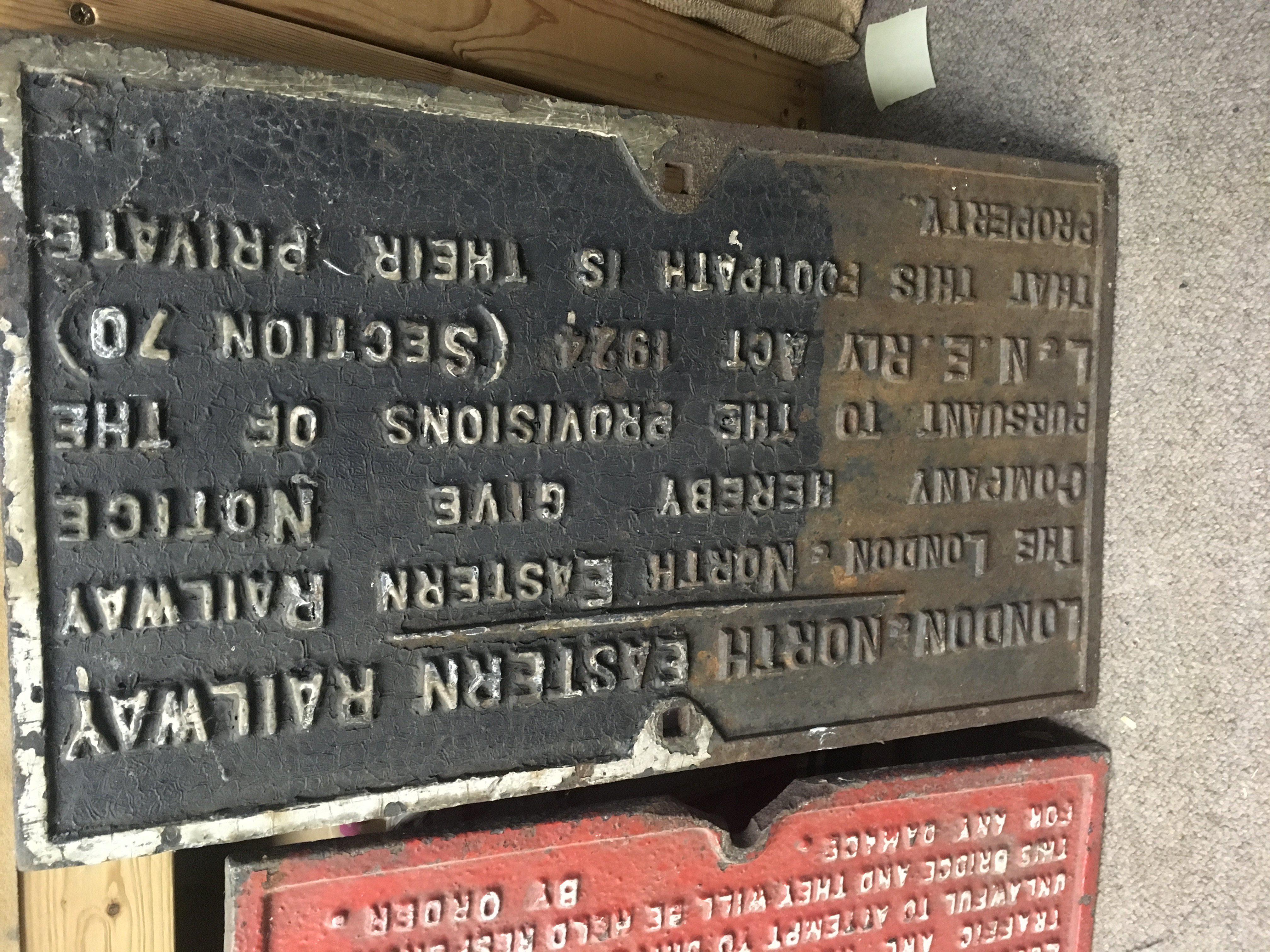 A cast iron railway sign London north eastern footpath notice .