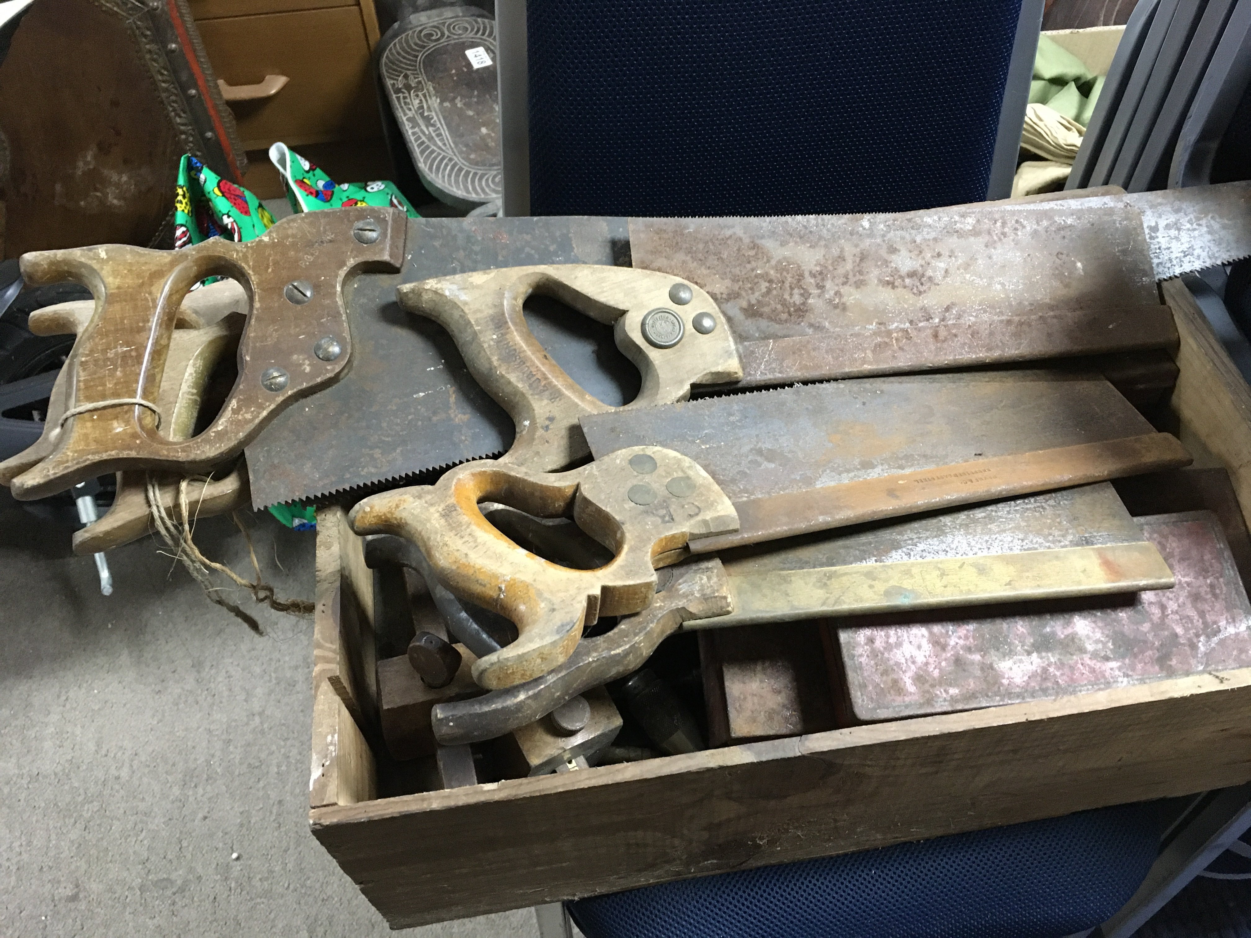 A collection of woodworking tools including saws, drill bits etc