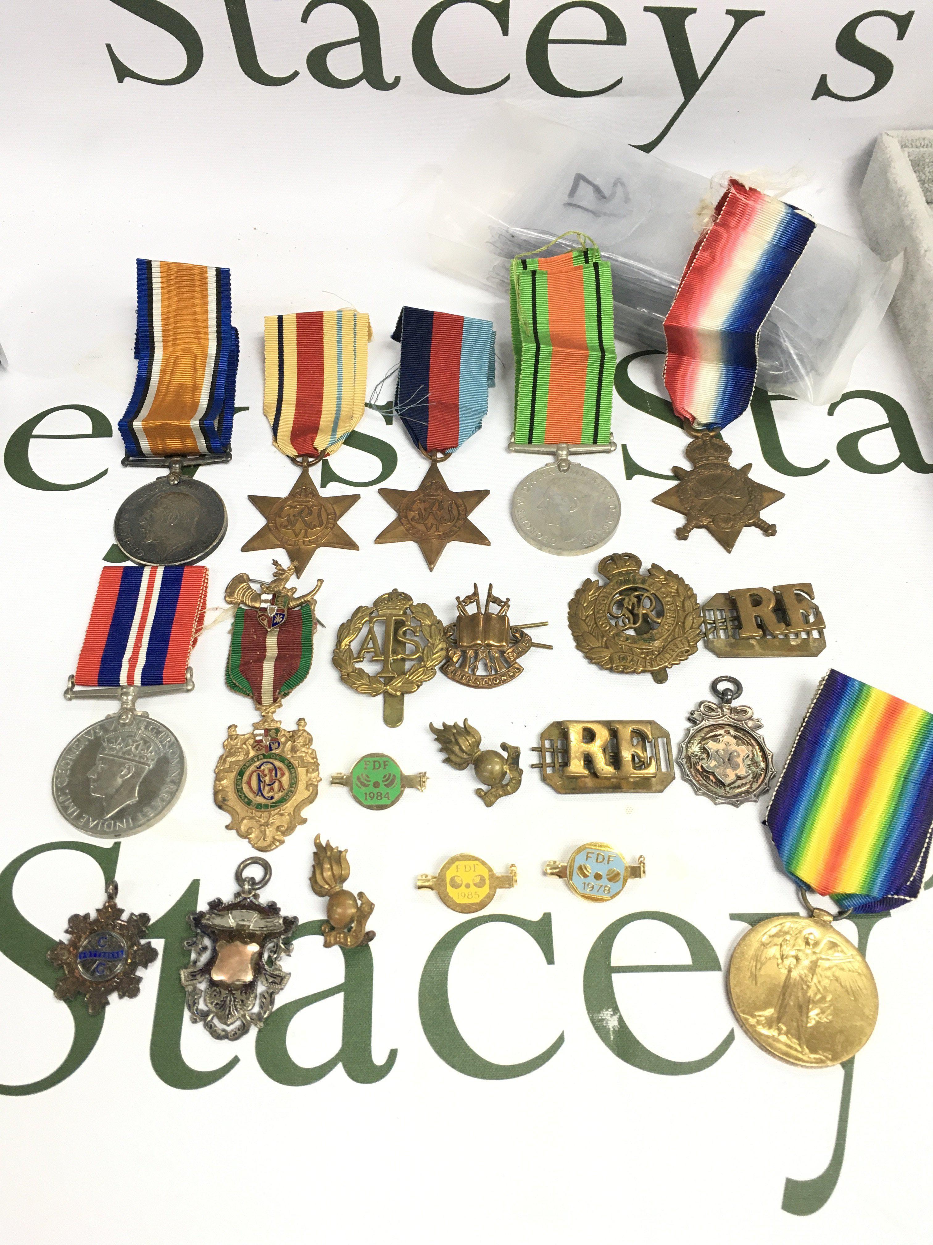 WW1 & 2 medals including WW1 1914-15 Star, War and Victory medals presented to a L-26168 GNR.S.J.CARSON .R.F.A, Africa Star, 1939-45 star, ww2 defence and war medals, Masonic medal, silver medal, cap badges etc. postage category b