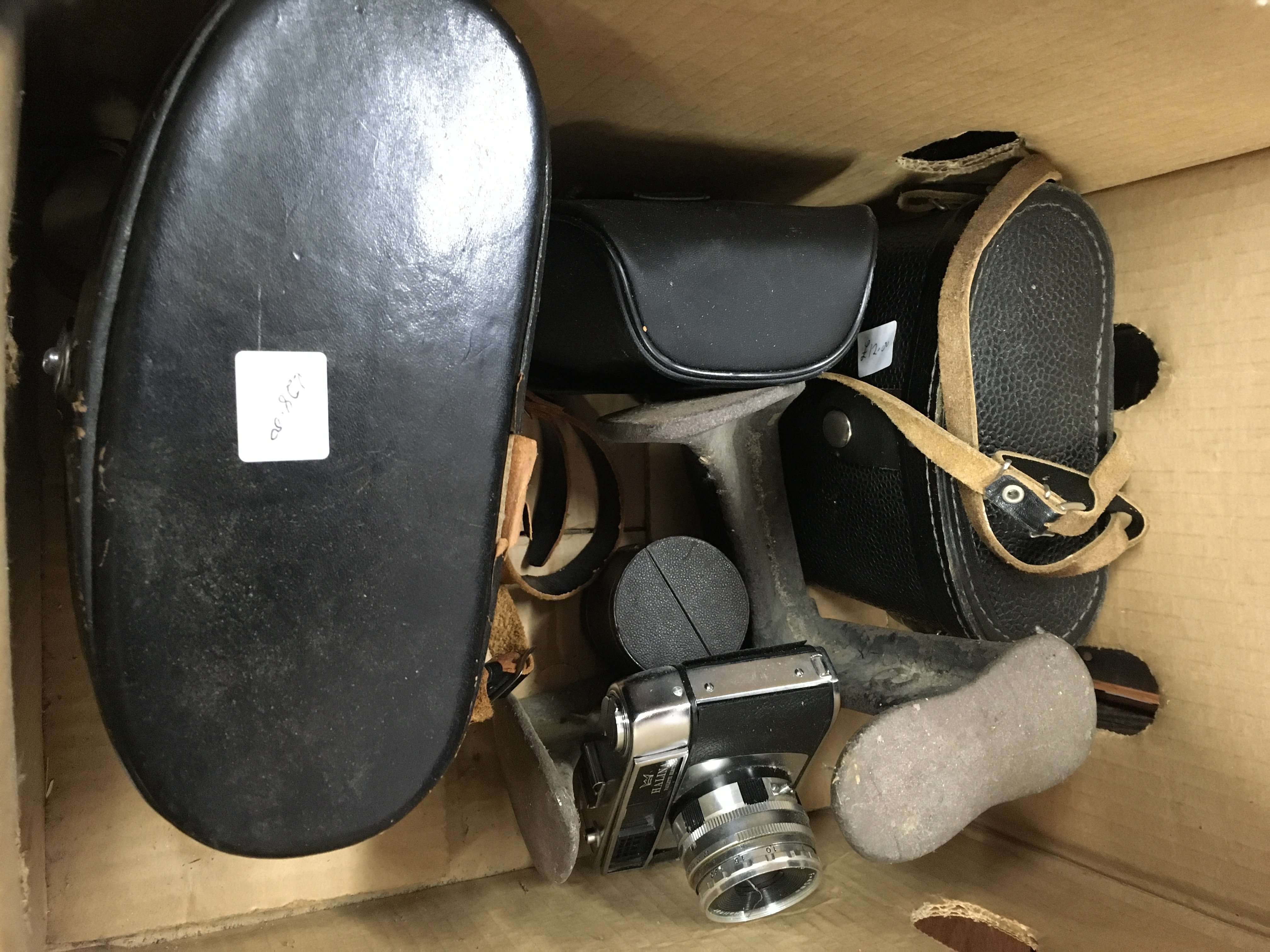A box containing a camera and two pairs of binoculars