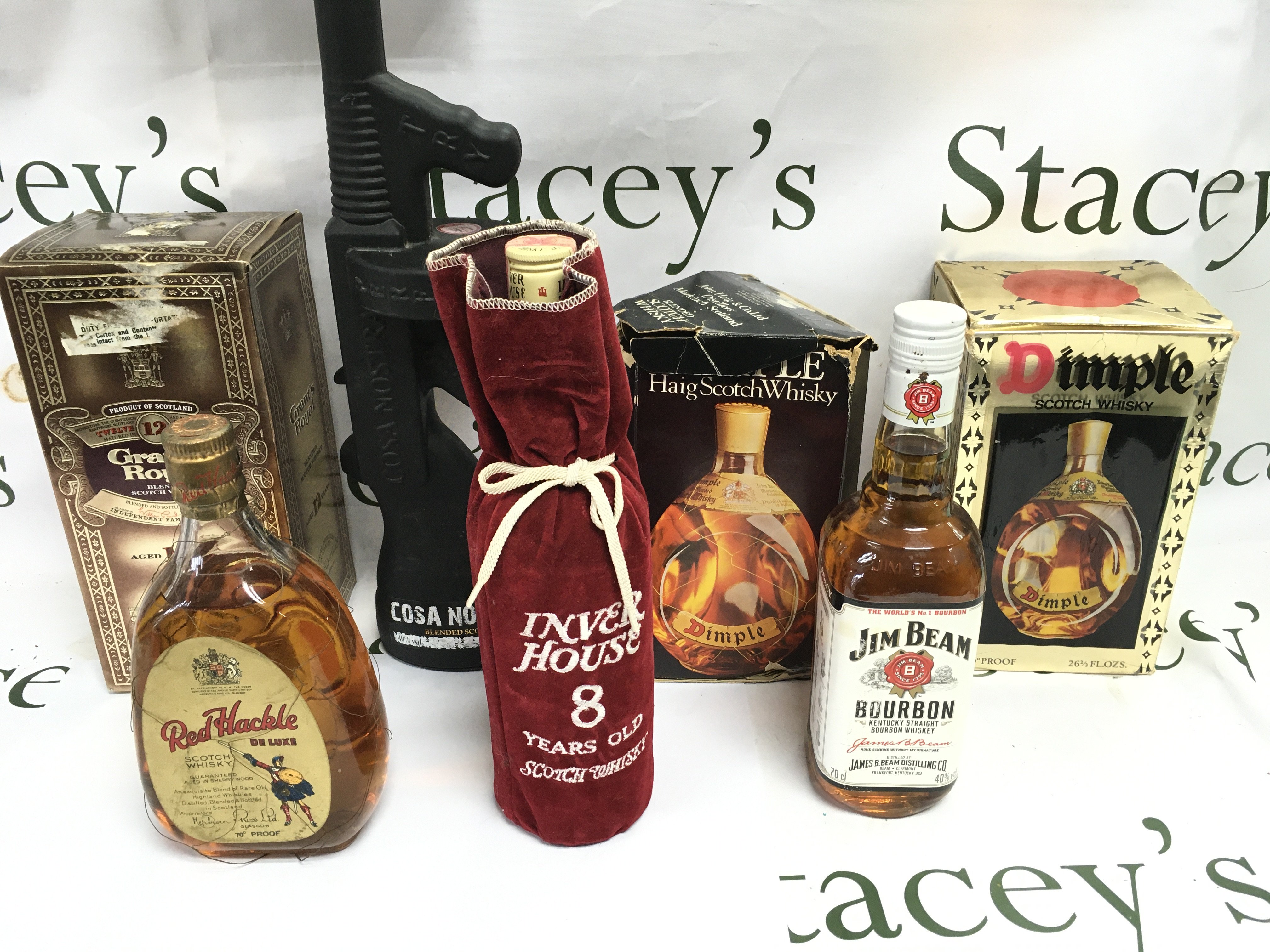 A collection of 7 bottles of various whiskey including Grants royal and dimple etc.