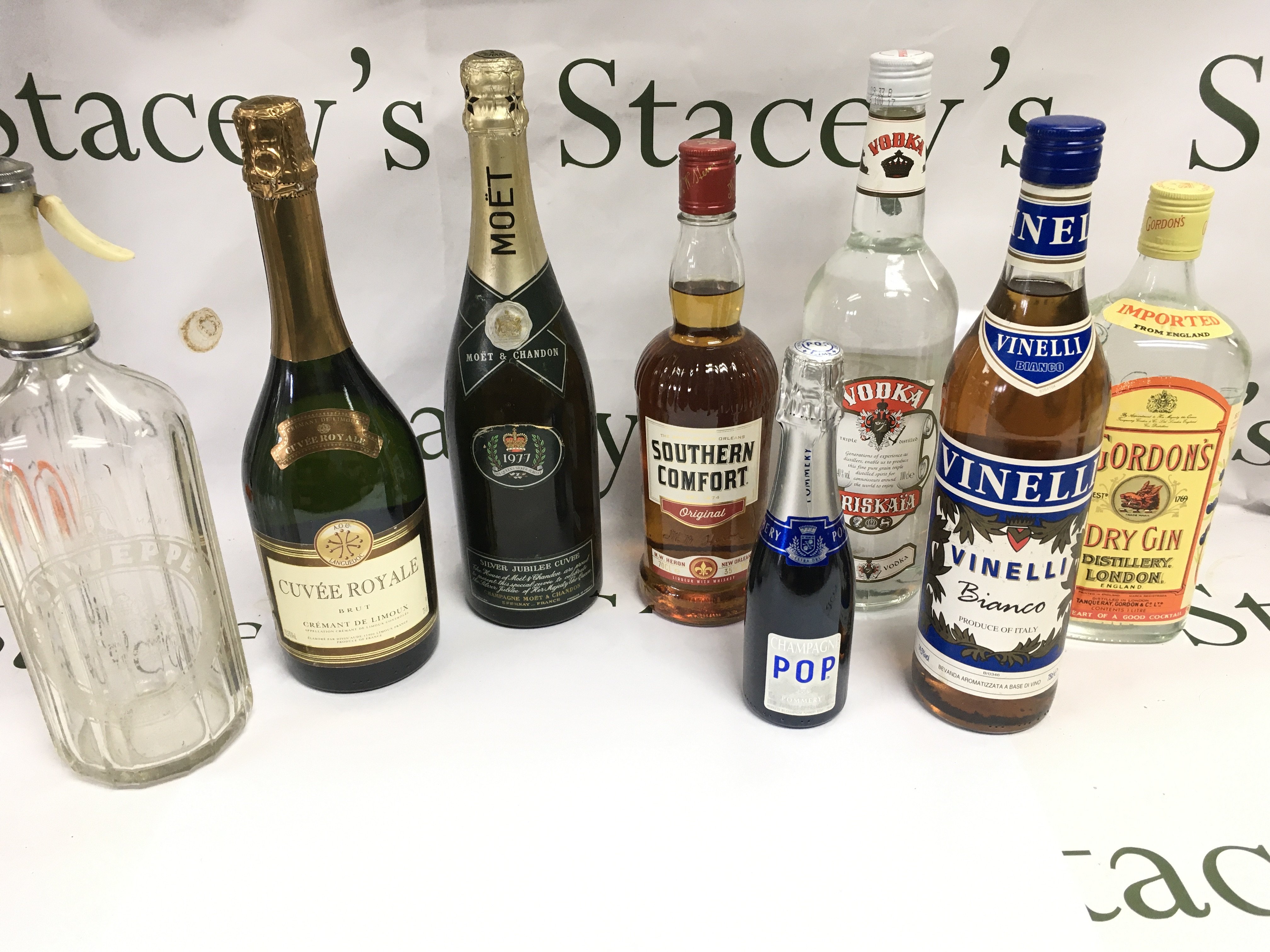 A collection of various bottles of alcohol including gin vodka champagne etc.