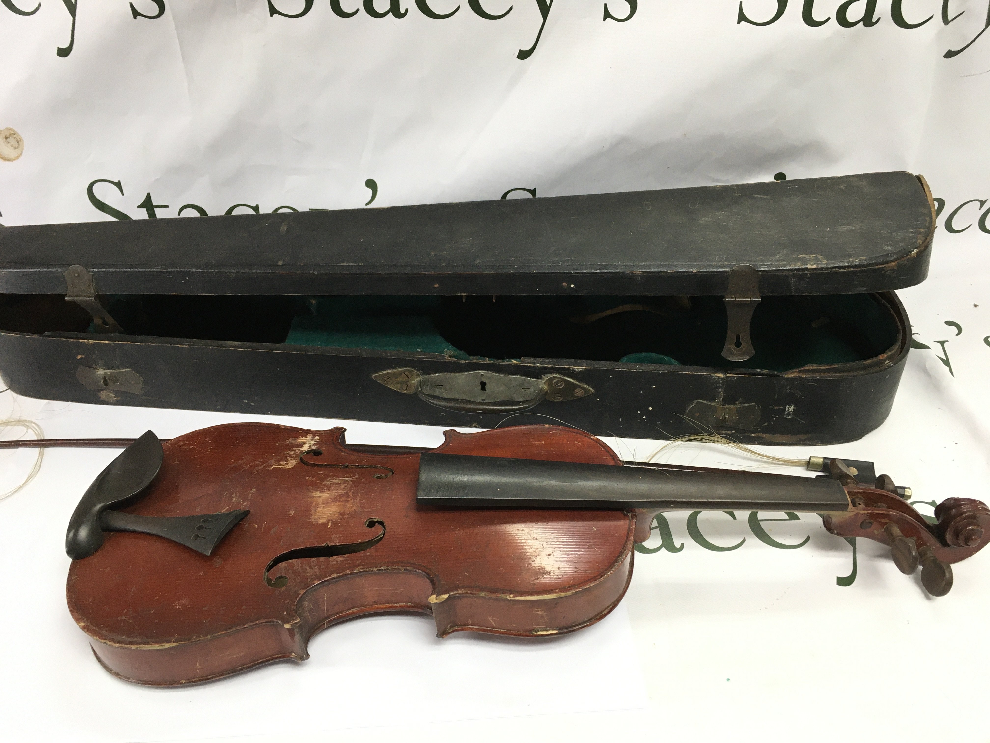 A 1930 cased violin in need of repair.
