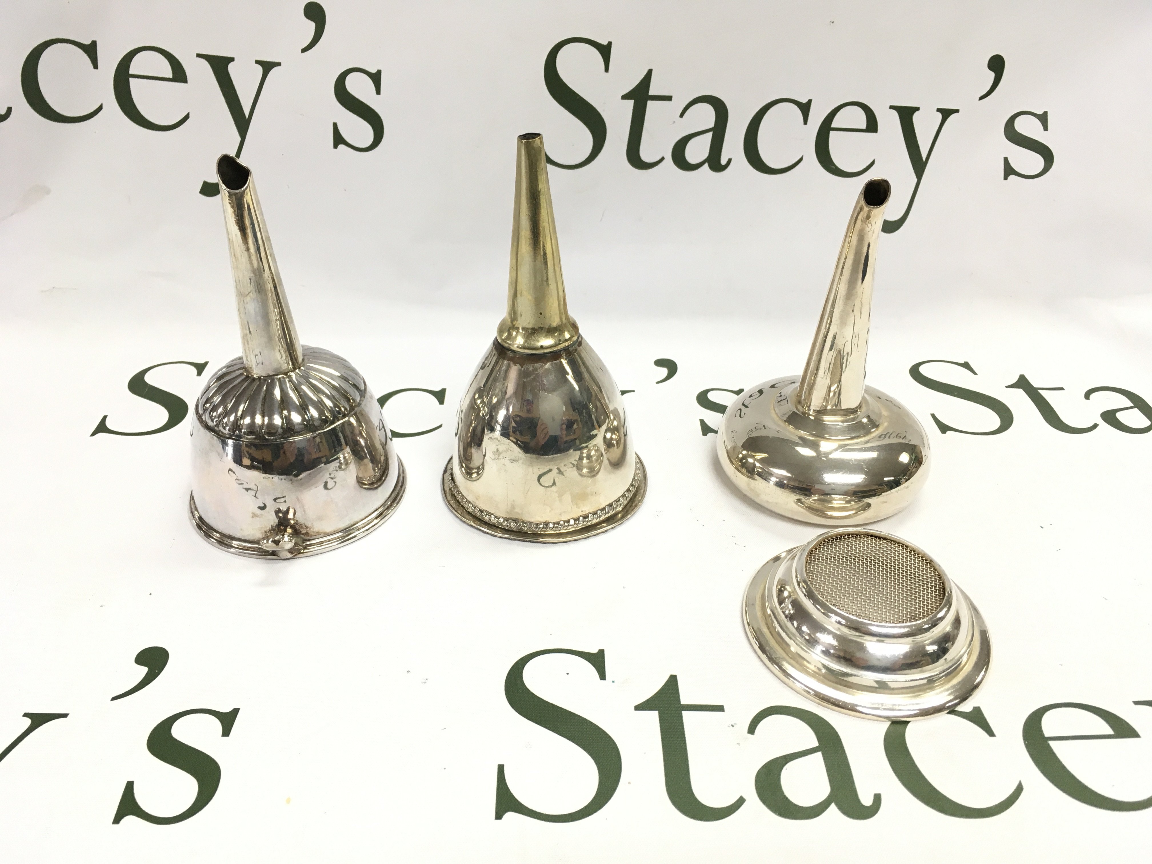 Three silver plated wine funnels. Postage B