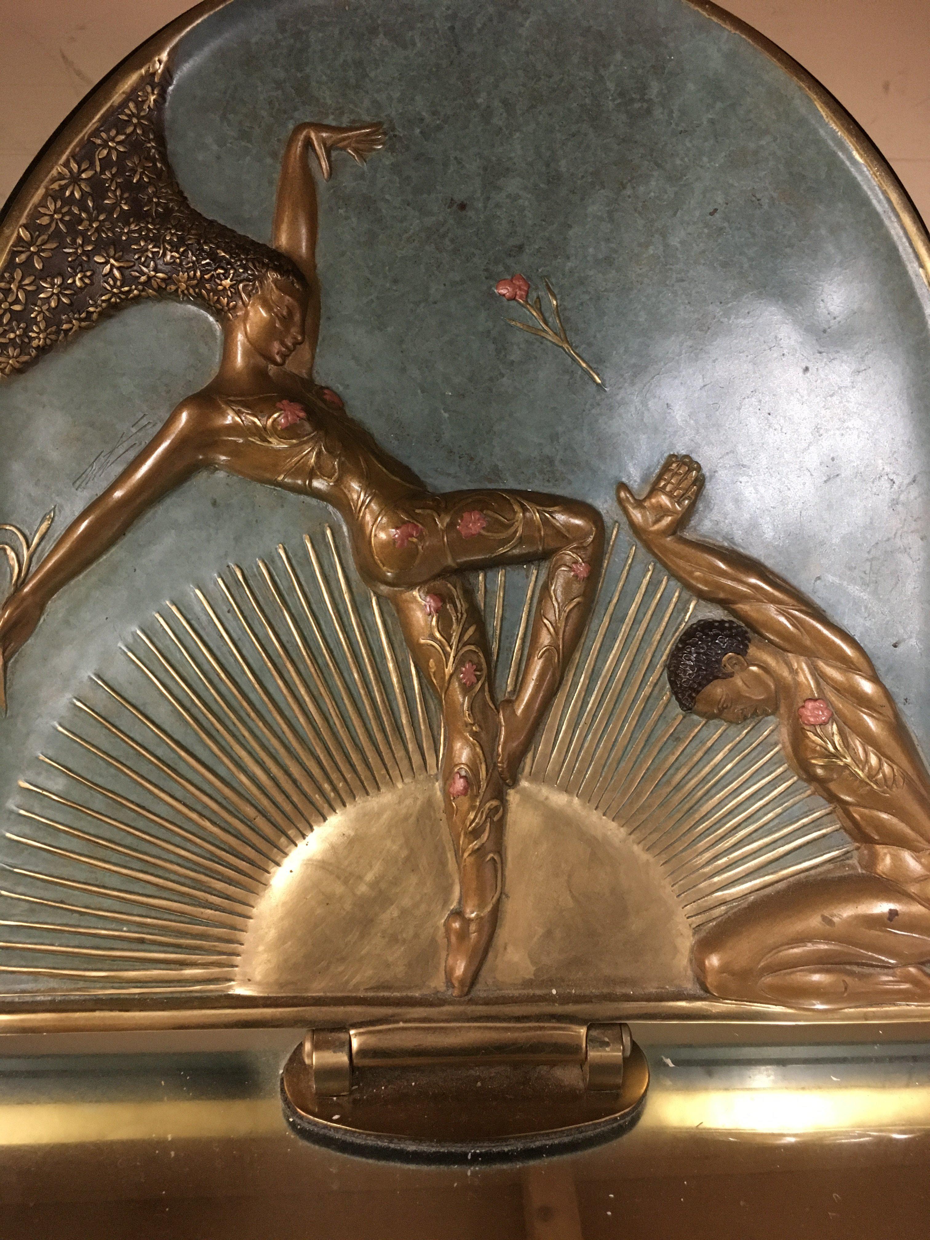 A Art deco Femme Fatale bronze revolving table mirror designed by Erte Romain de Tirtoff Depicting two dancers in front of a gilt sunburst. 40 x 42 cm 34 cm heigh .