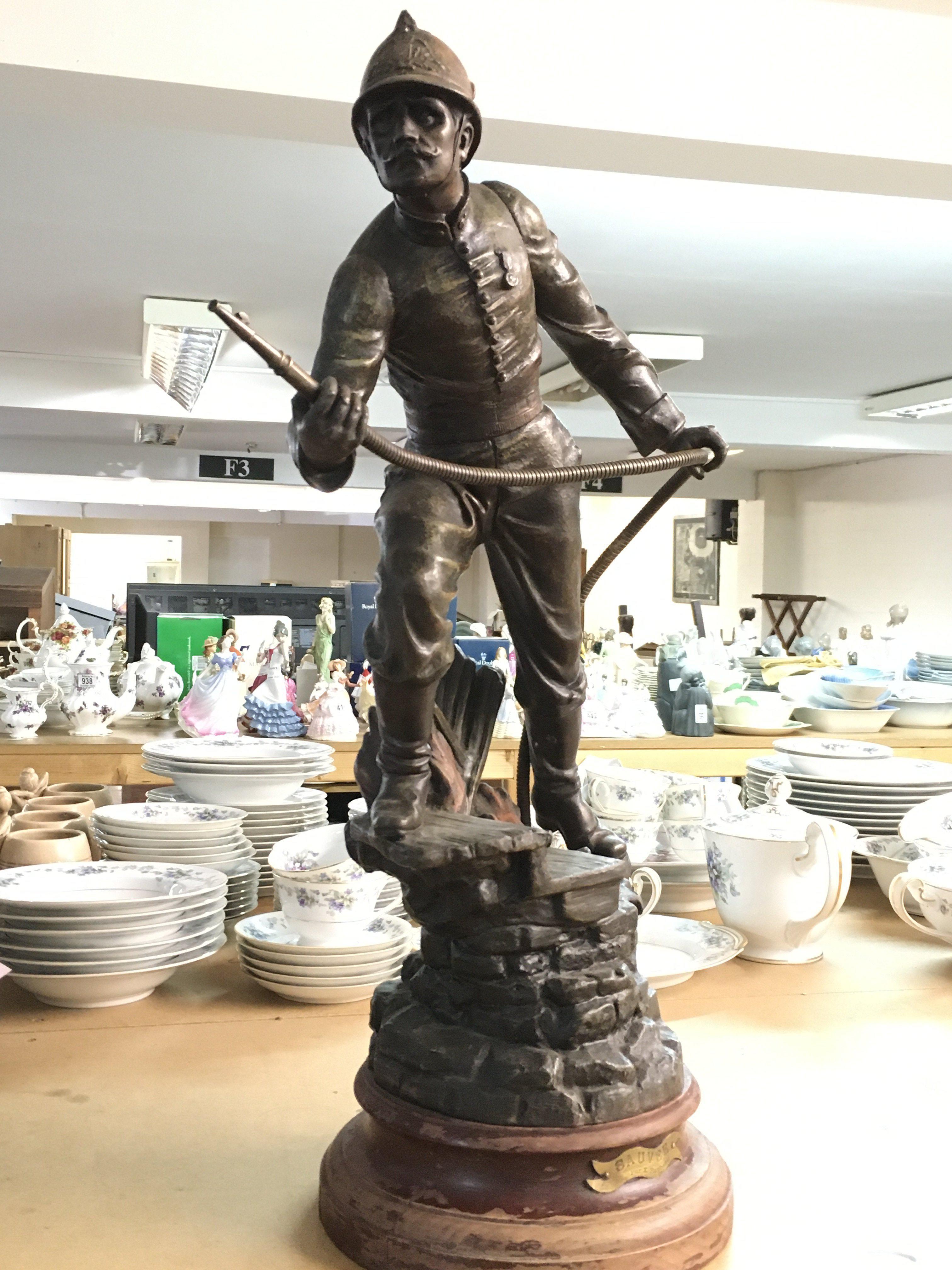 A French spelter figure of a fireman, marked Sauvee Par X Raphanel. 59cm tall.