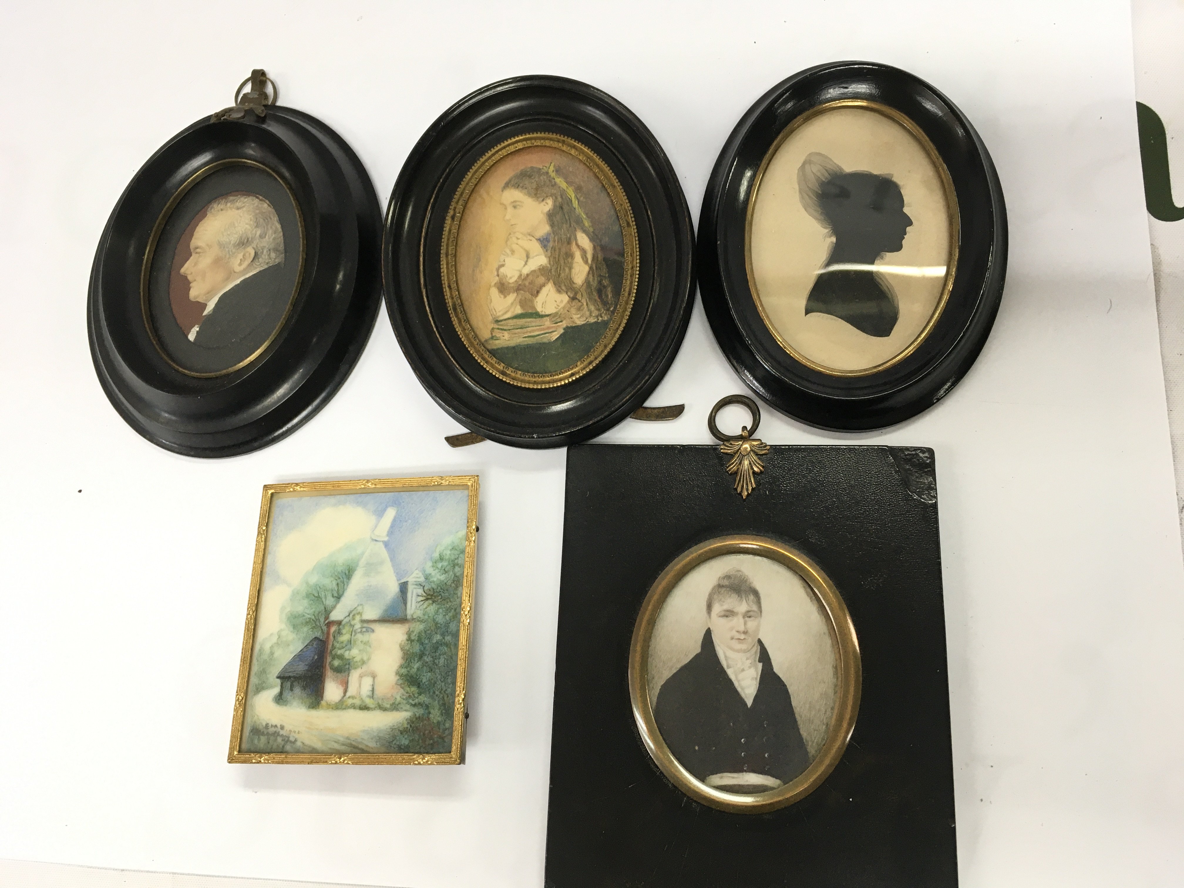 A gilt framed miniature of Chartham Kent, together with four portrait miniatures including a Victorian silhouette