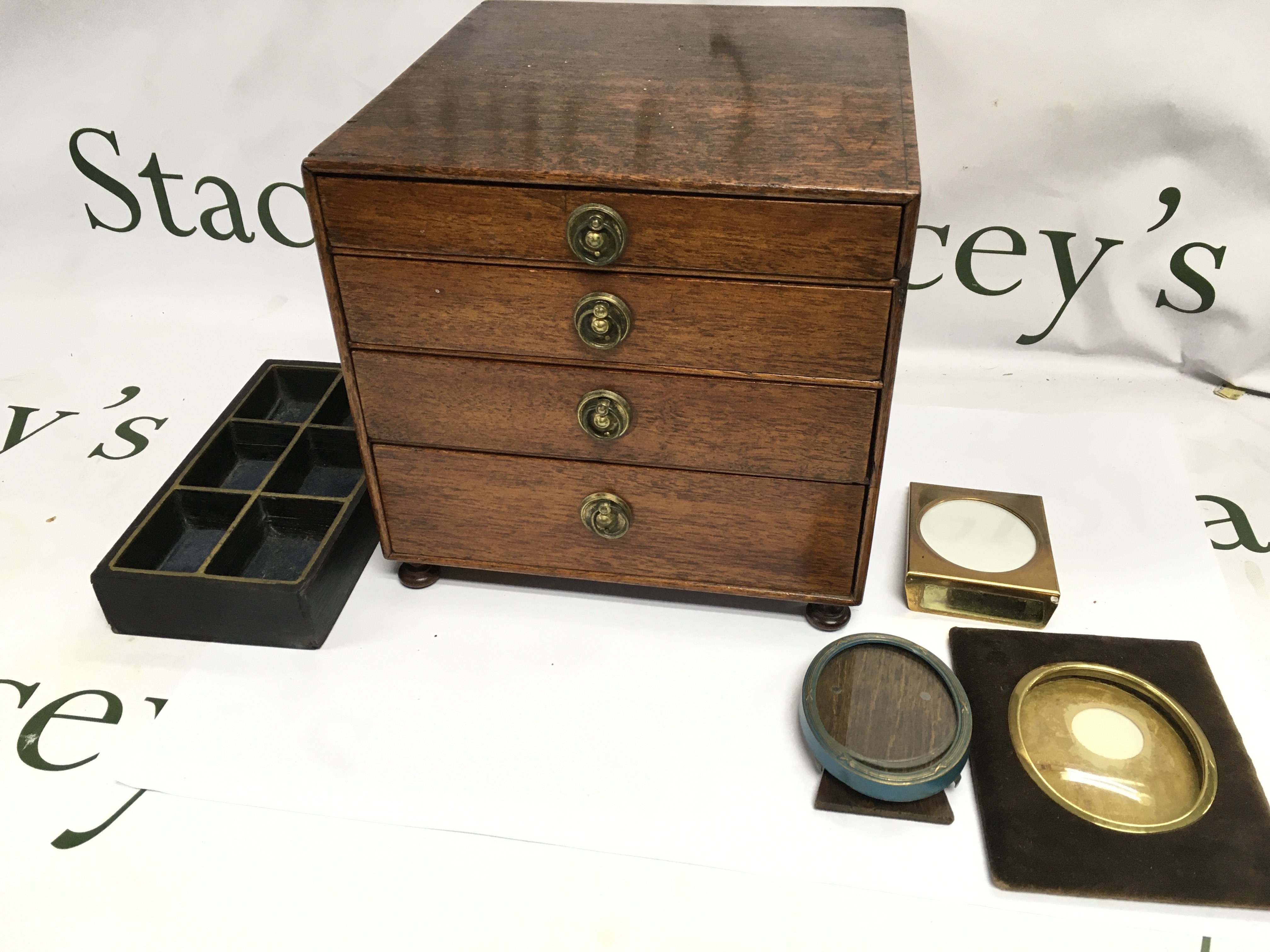 A small mahogany collectors cabinet and some miniatures frames. 20cm wide 19.5cm tall and 23cm deep.