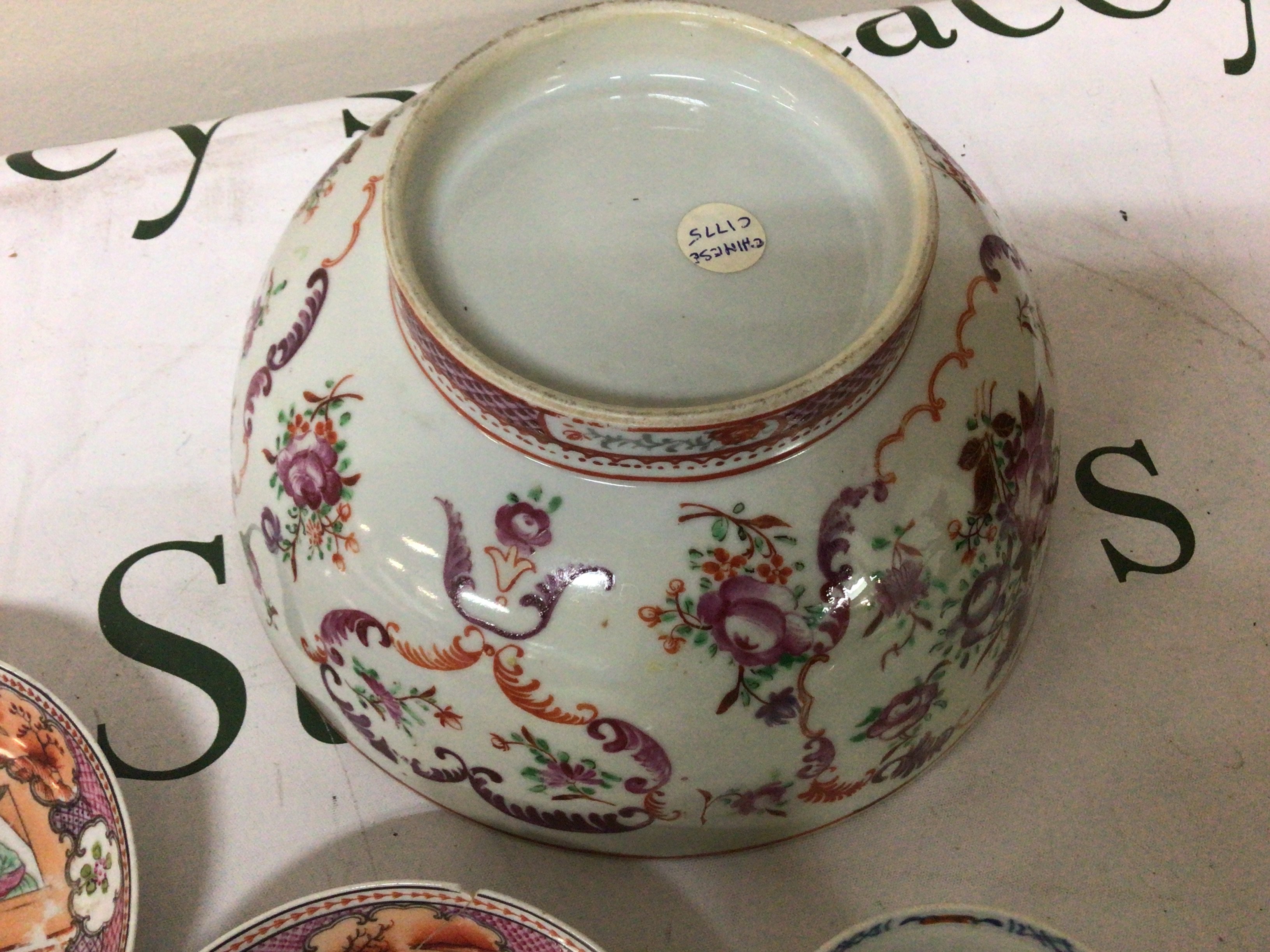 An 18th Century Chinese Export porcelain bowl painted with scrolls and foliage a pair of dishes decorated with figures and a tea bowl (some damage)- NO RESERVE