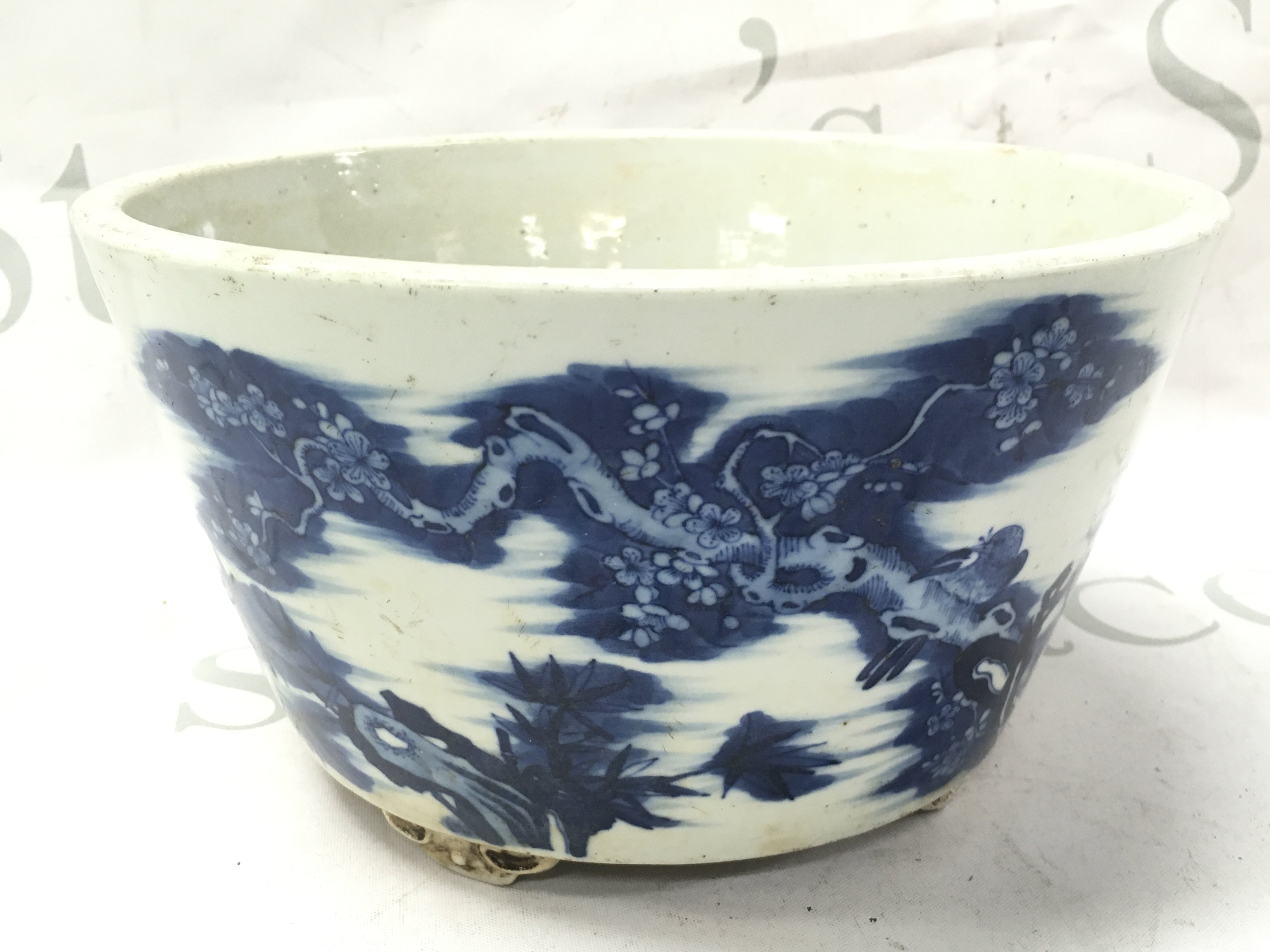A Chinese blue and white planter bowl decorated with birds perched on cherry blossom trees. 11.5cm tall 21cm wide Approx . This lot cannot be posted