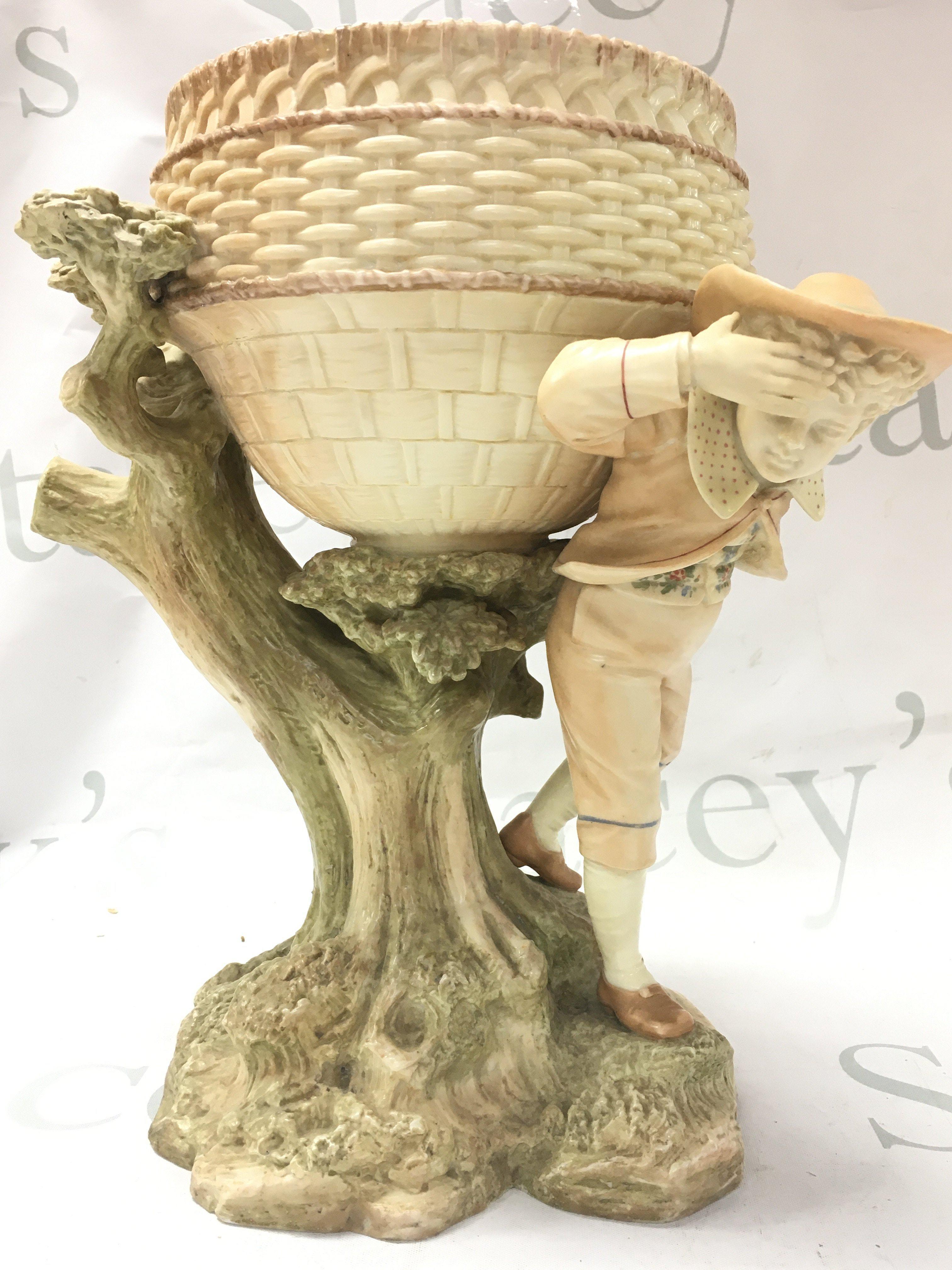 A Royal Worcester porcelain centre piece, with shaped bowl, on a tree bough aside figure 18cm tall. This lot cannot be posted