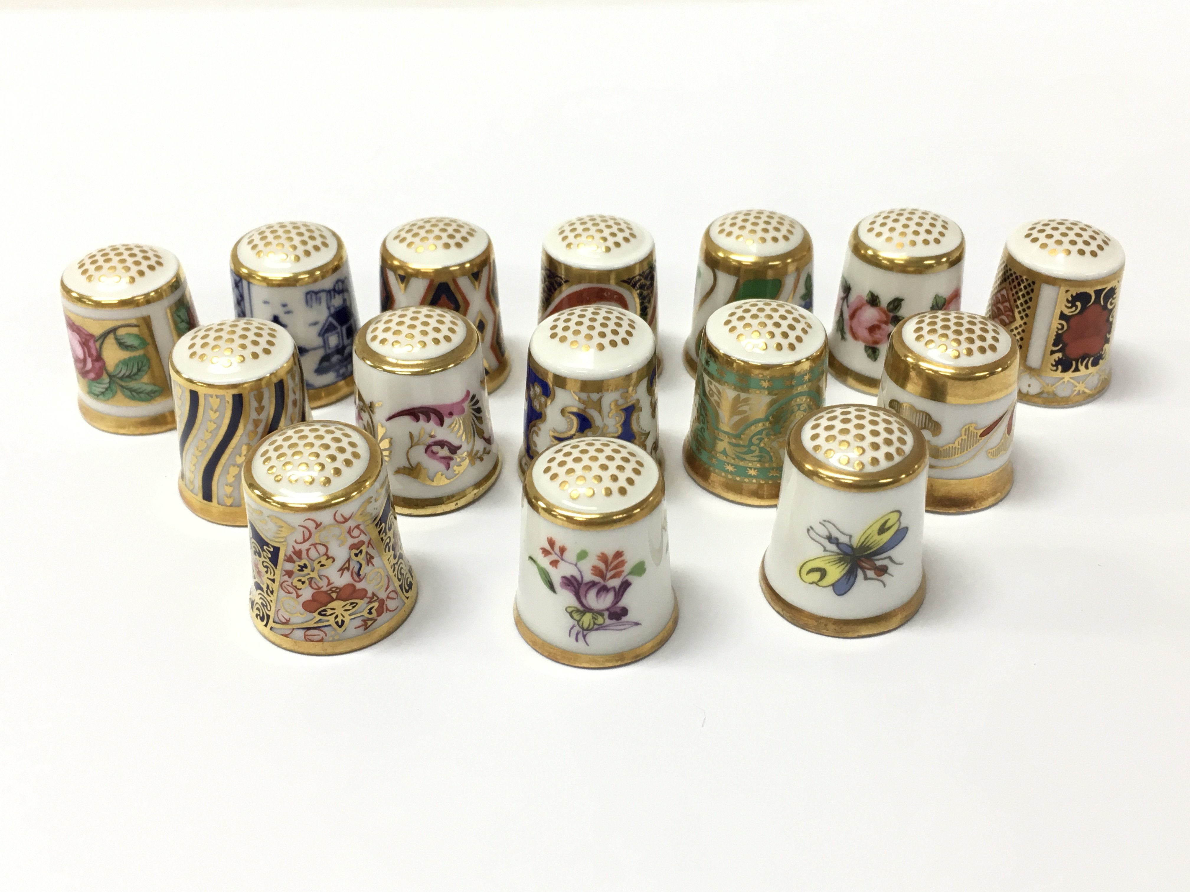 A collection of Royal Crown Derby ceramic thimbles . This lot cannot be posted