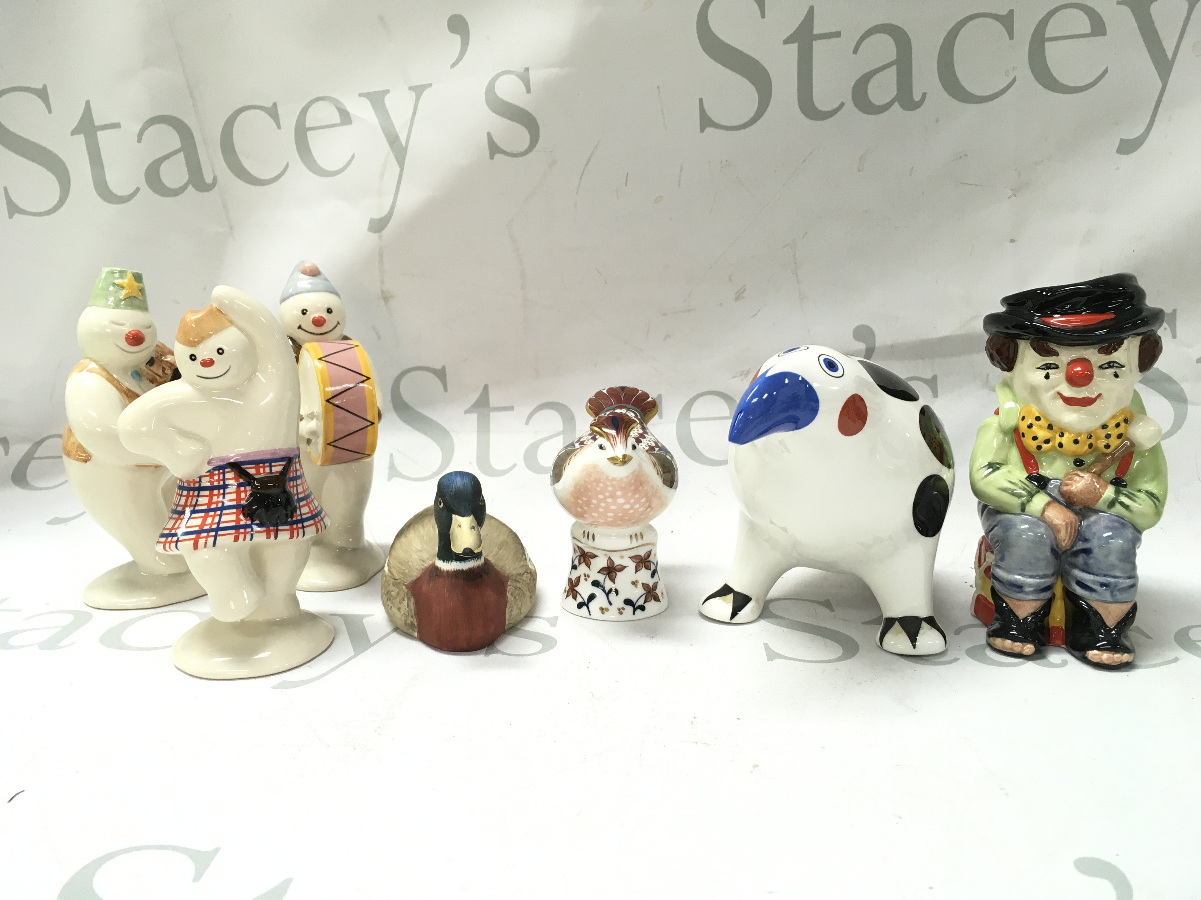 A collection of ceramics including Royal Doulton The Clown, Villeroy & Boch, Minton flights of fantasy, Royal Doulton snowman figures, Doulton flower basket . This lot cannot be posted