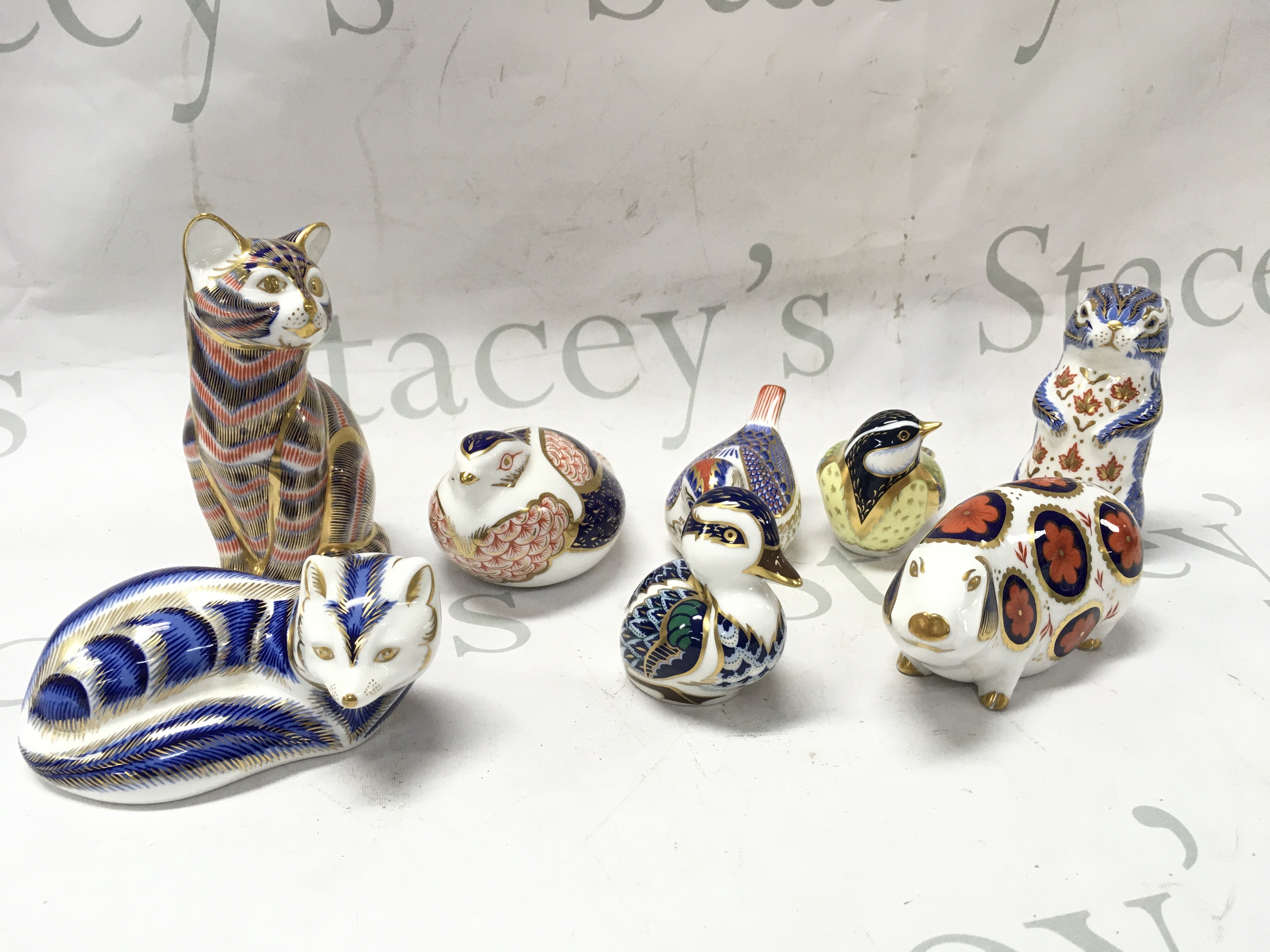 A collection of Royal Crown Derby porcelain paperweights , some with gold stoppers. This lot cannot be posted