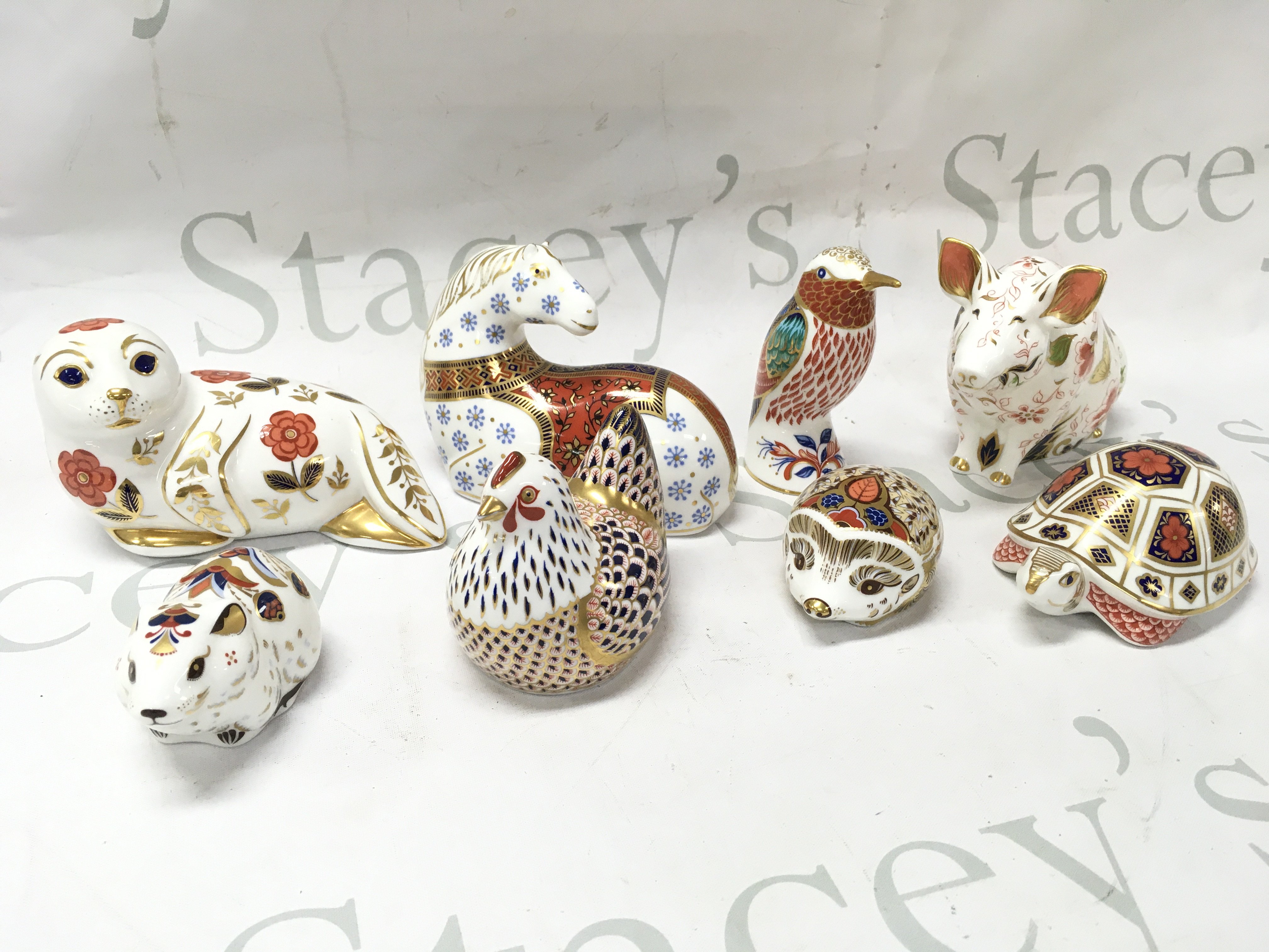 A collection of Royal Crown Derby paperweights , some with gold stoppers. This lot cannot be posted