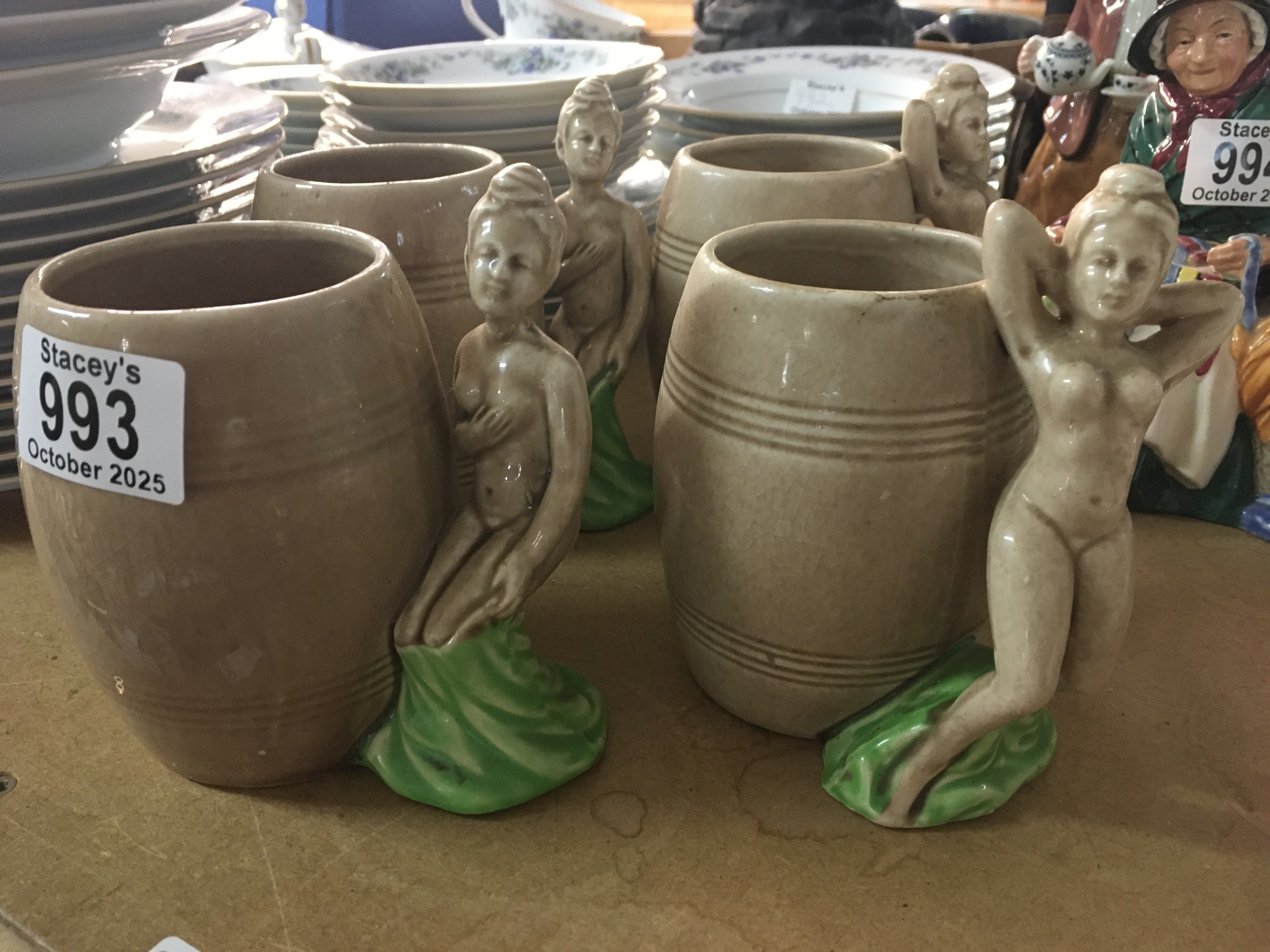 A set four Dorothy Kindell pottery mugs the handles in the form of nude maidens.