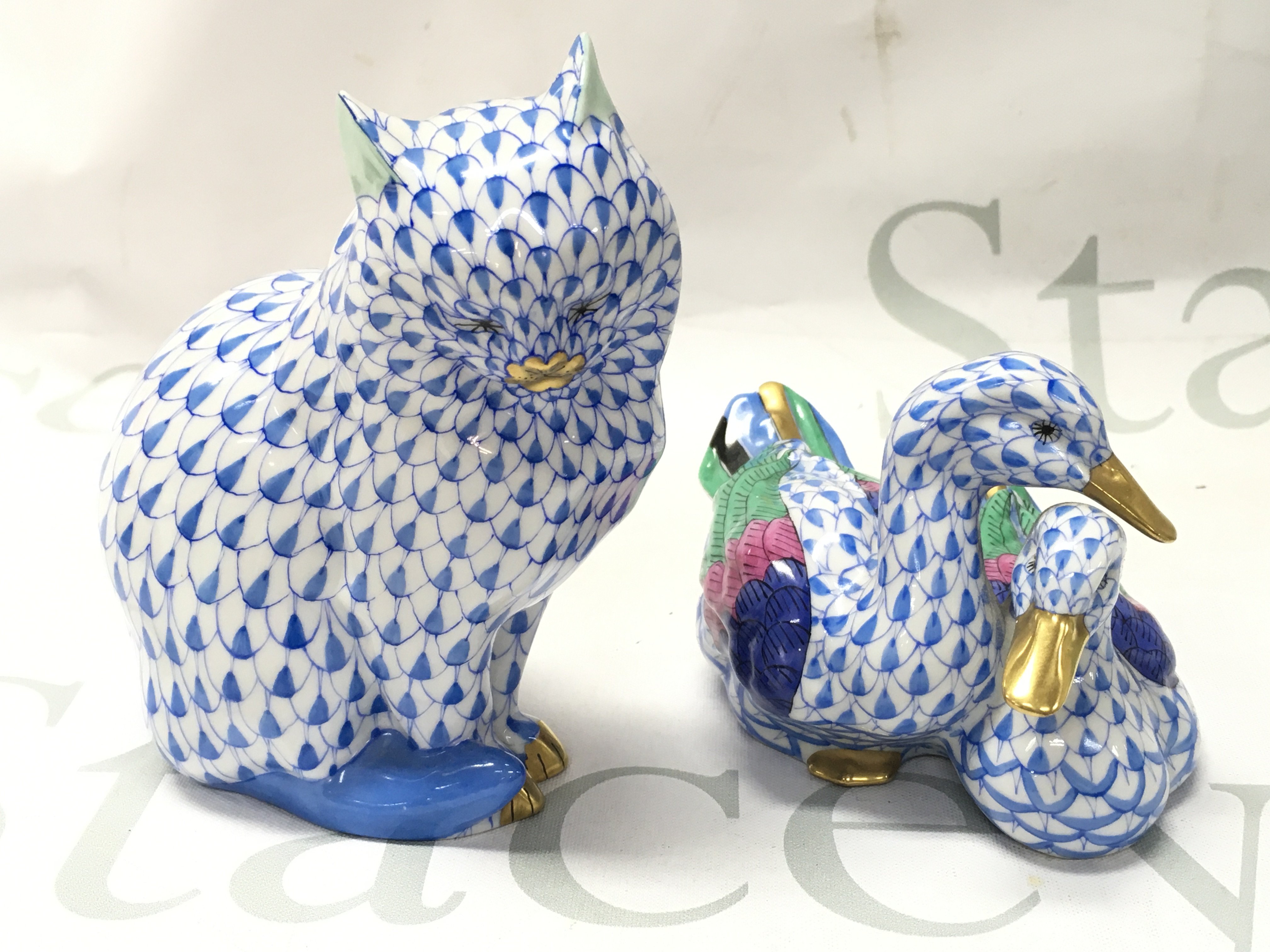 Two Herend porcelain figures , a cat and duck figure group. This lot cannot be posted