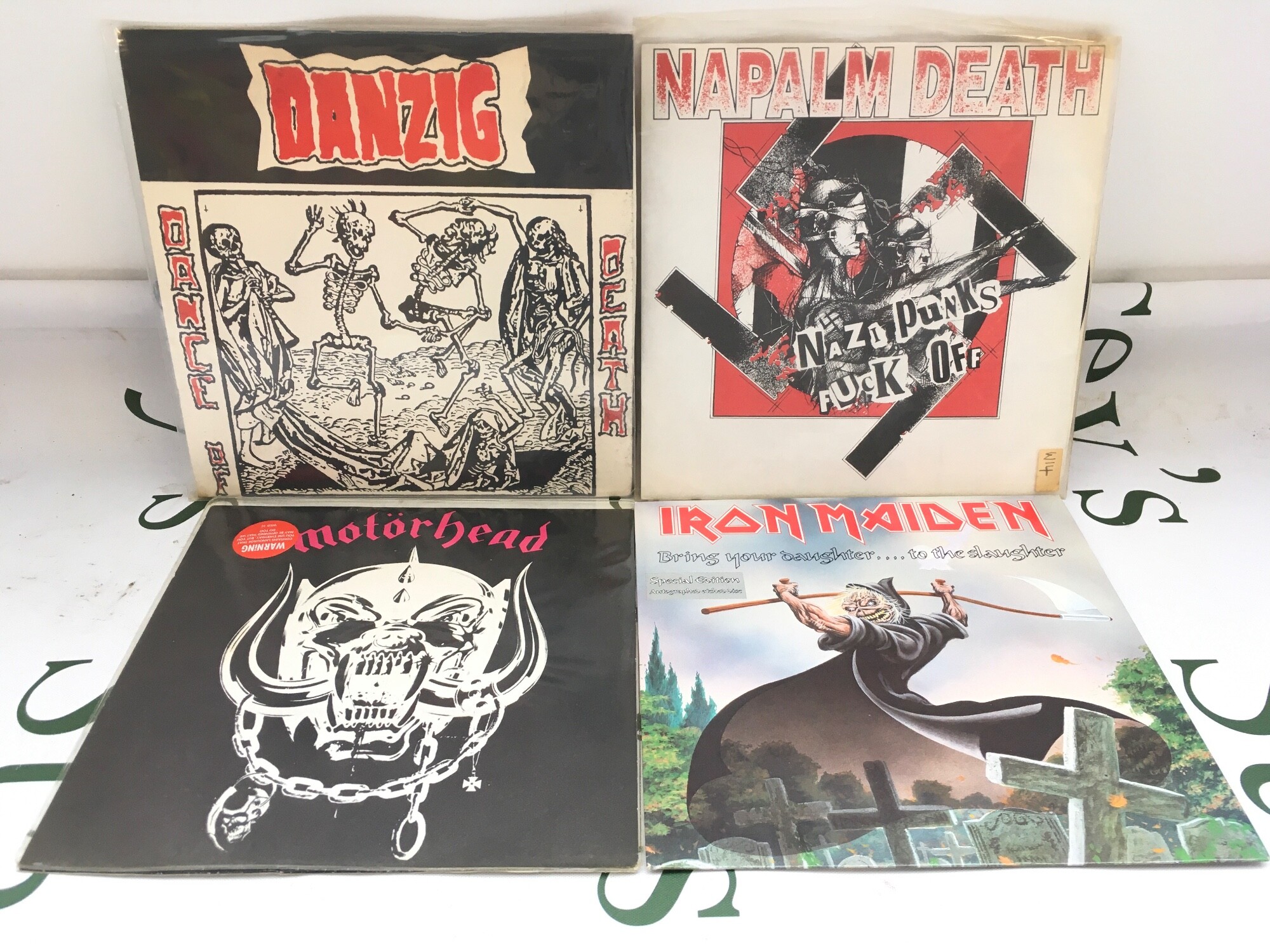 Four hard rock 7" singles by Danzig (limited edition pressing), Motörhead, Napalm Death and Iron Maiden.