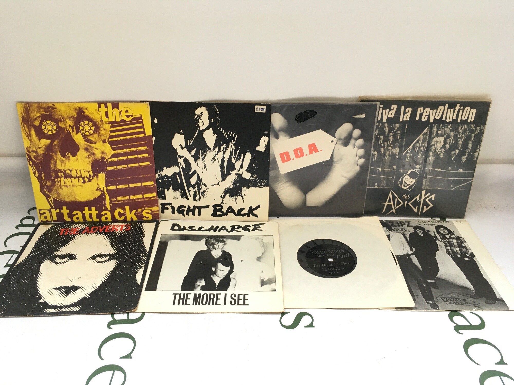 Eight punk 7" singles by various artists including The Adverts, The Art Attacks, Discharge and others.