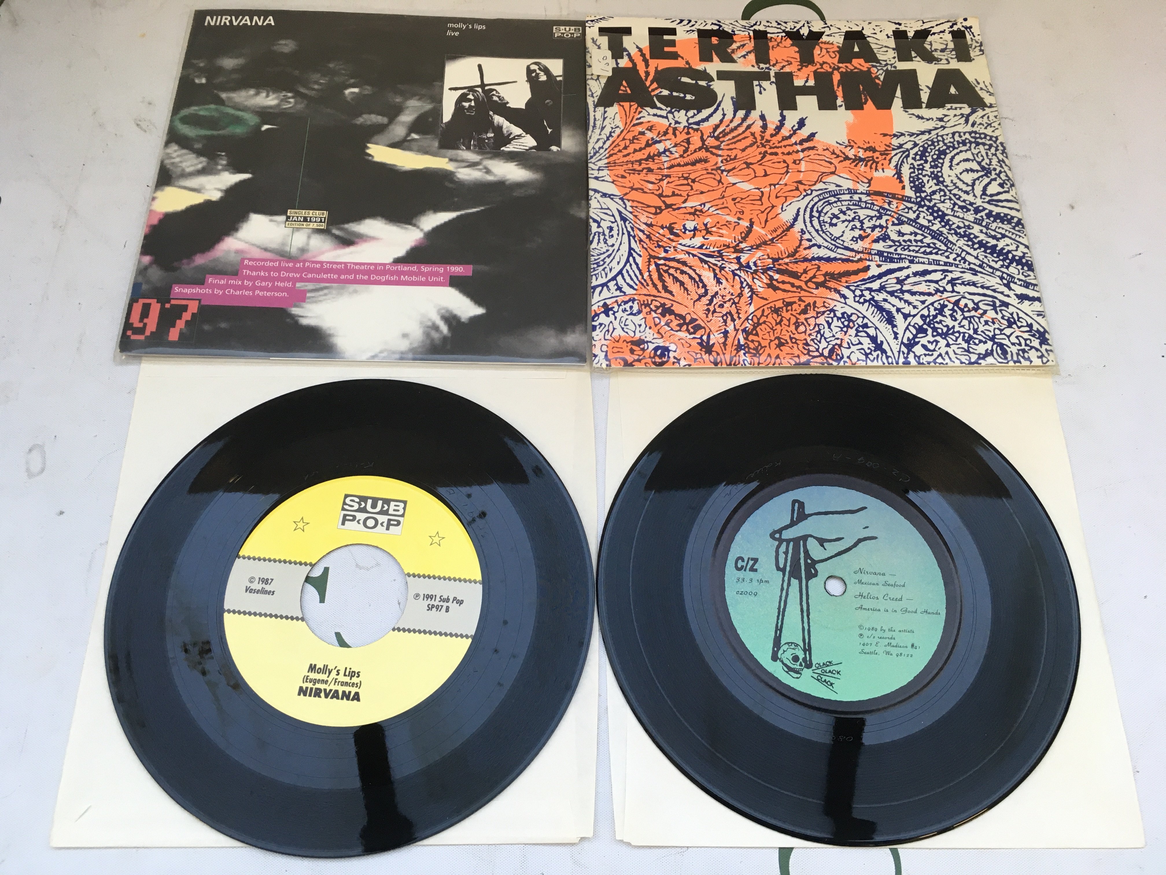A limited edition Sub Pop singles club 7" single of Molly's Lips by Nirvana / Candy by The Fluid plus a 1989 four track compilation EP Teriyaki Asthma featuring Nirvana, Helios Creed, Yeast and Coffin Break. Both EX/EX.