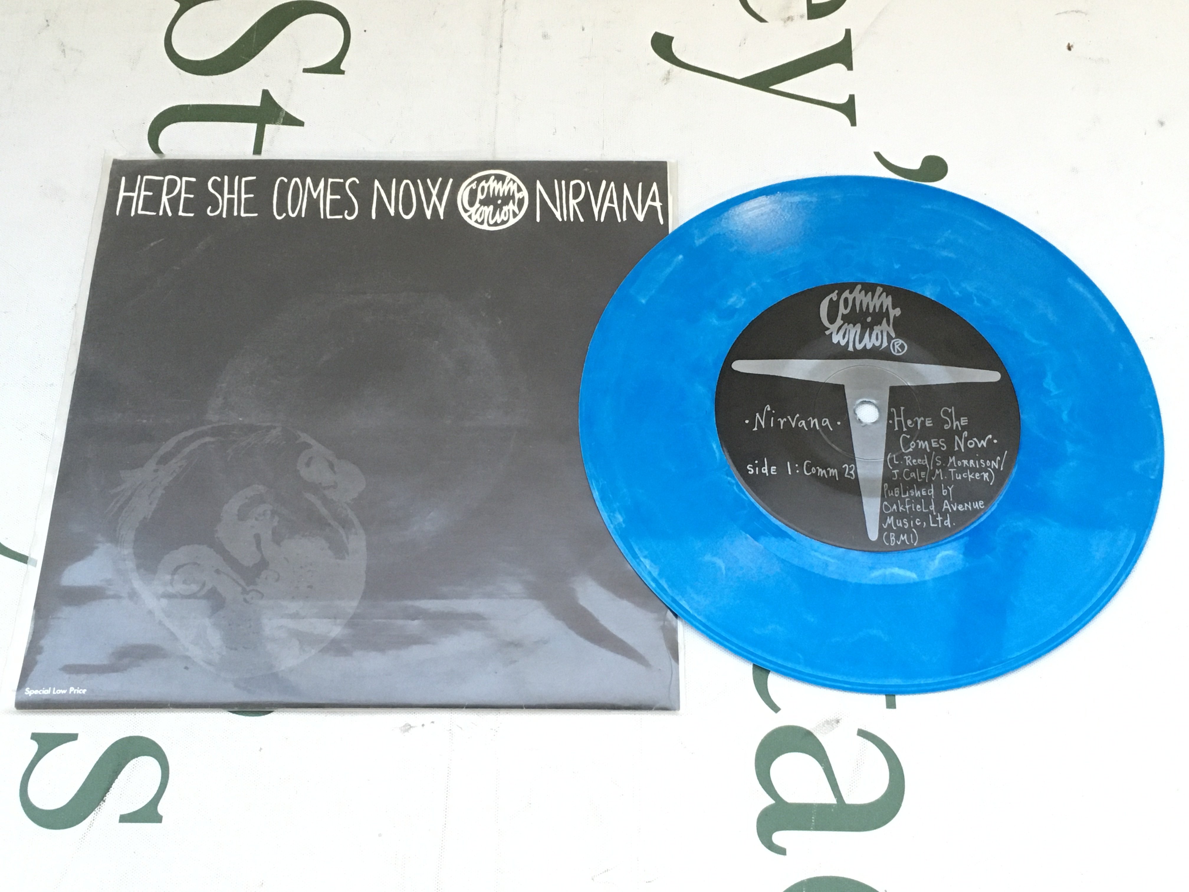 A limited edition split 7" single on blue marbled vinyl featuring Here She Comes Now by Nirvana and Venus In Furs by Melvins. Believed to be one of  only 1000 copies distributed worldwide. EX/EX. 