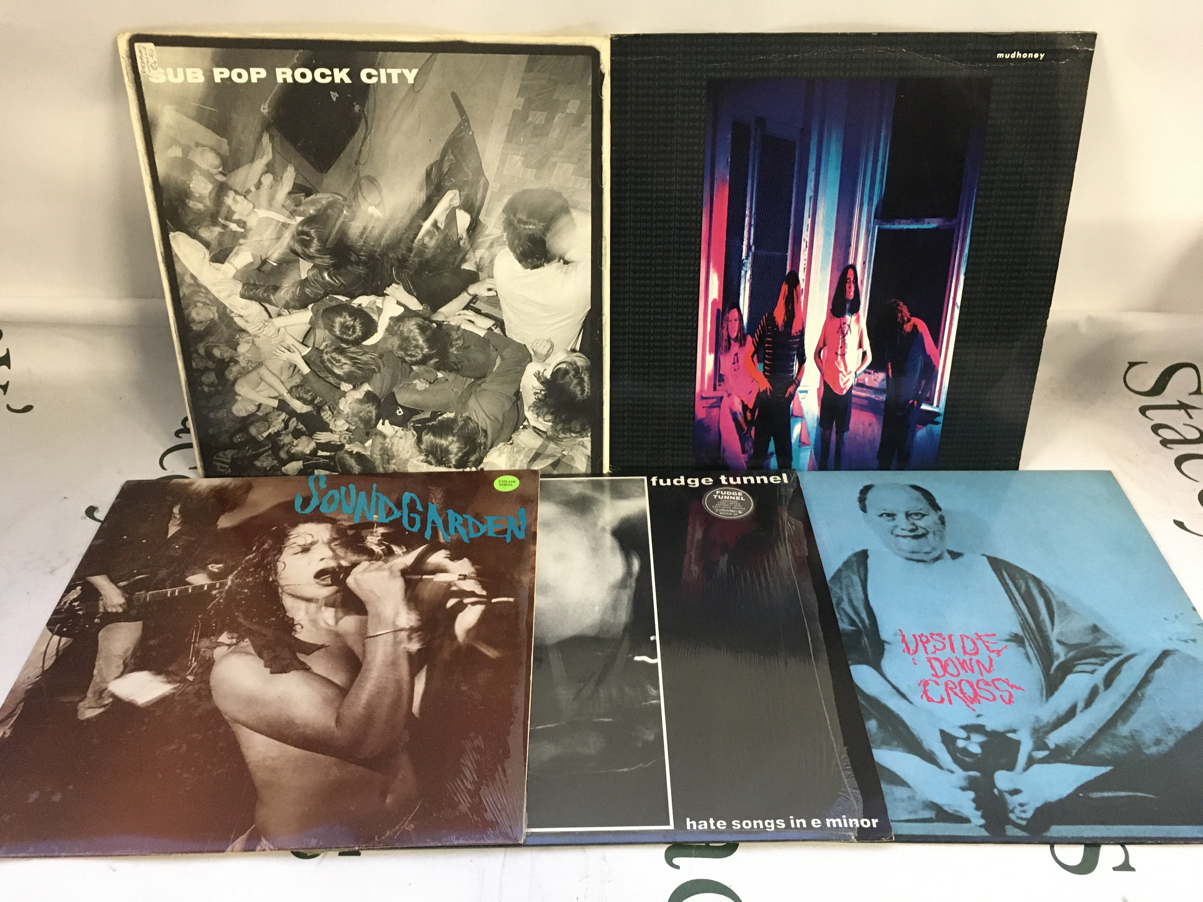 Five grunge LPs and EPs comprising a blue marbled pressing of Screaming Life by Soundgarden, a Sub Pop Rock City compilation, the self titled Mudhoney LP and others. Condition generally EX.
