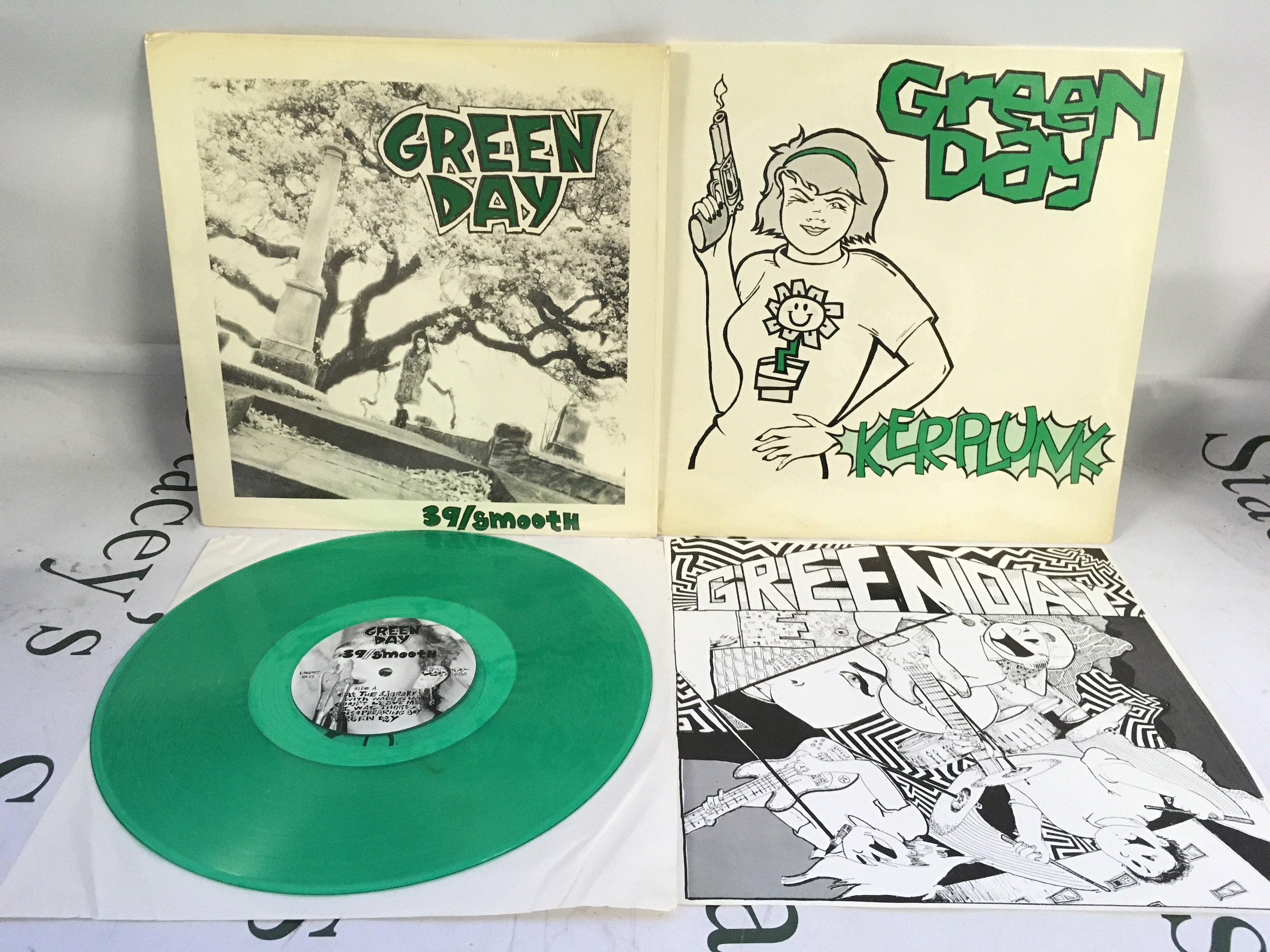 Two first US pressings of early Green Day LPs comprising a sealed Kerplunk! and a green vinyl pressing of 39/Smooth complete with insert. Mint/EX.