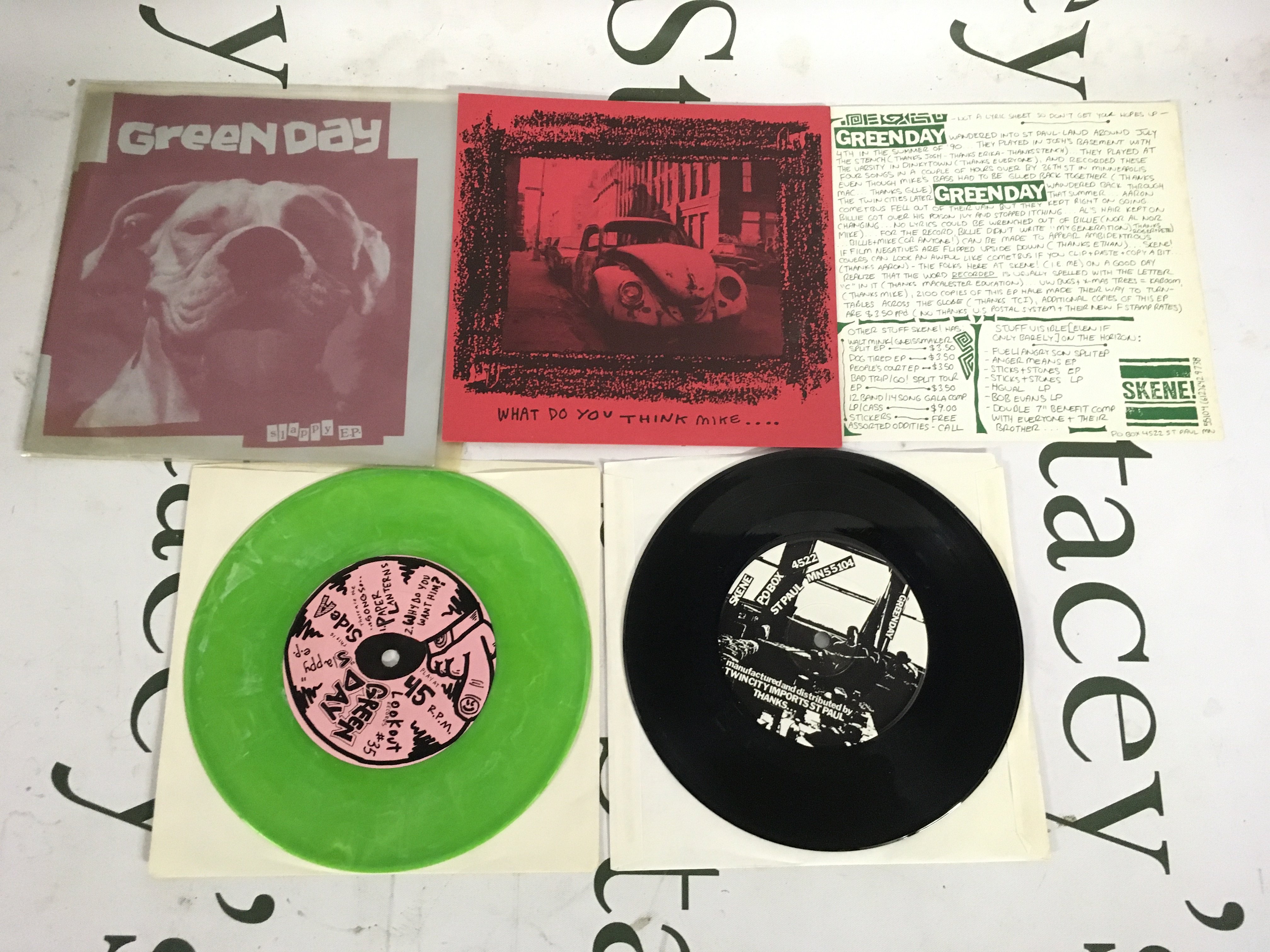Two early Green Day EPs comprising a green vinyl pressing of the Slappy EP and a limited edition reissue of Sweet Children complete with insert. 