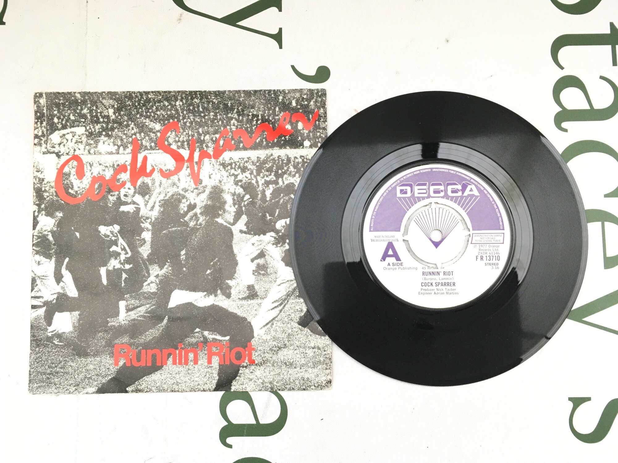 A promo 7" disc for Runnin Riot by Cock Sparrer. Vinyl EX.