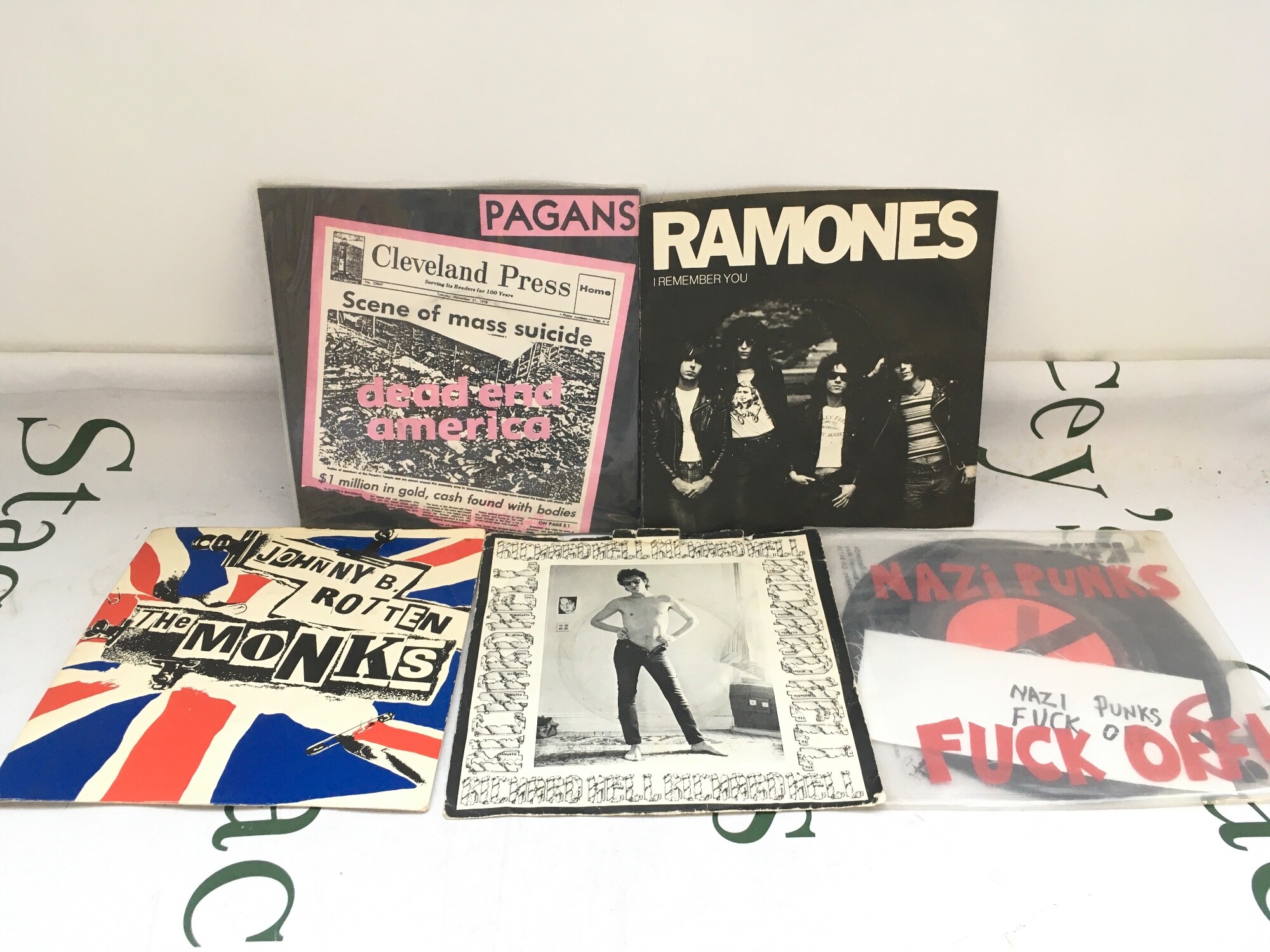 Five punk 7" singles comprising a Richard Hell plug copy of Another World numbered 0001 plus releases by Pagans, Ramones, Dead Kennedys and The Monks (promo disc).