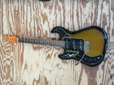 A left handed and signed Burns Marquee Club Series electric guitar in greenburst finish. Has been signed to the back of the headstock by Brian 'Licorice' Locking, famed for his work with The Shadows, Cliff Richard and Vince Taylor. Comes with a hard carry case.