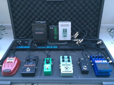 A Boss BCB-60 pedal board with various effects pedals including a Digitech Mosaic 12 string, Ibanez tube screamer, TC Electronic Quintessence and others.