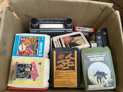 A box of 8 track cartridges and in car 8 track player.