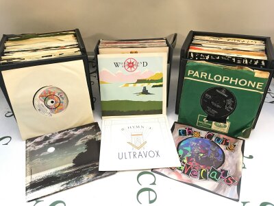 Thre record cases and a box of 7" singles by various artists including The Beatles, Queen, The Cure and many more.