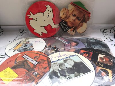 A box of LPs and 12" singles comprising many picture discs by various artists including David Bowie, Queen, Genesis and others.