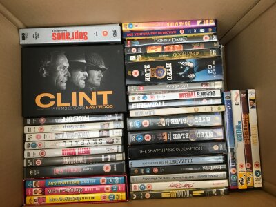 Two boxes of DVDs including box sets of various TV series and films.
