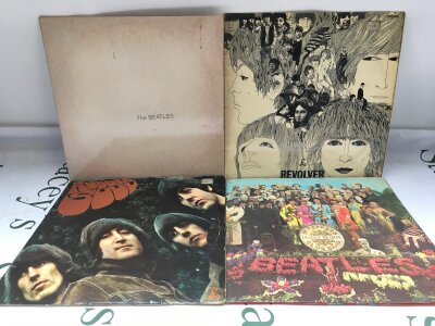 Four Beatles LPs comprising a Canadian pressing of the White Album plus early UK pressings of Revolver, Rubber soul and Sgt Pepper.
