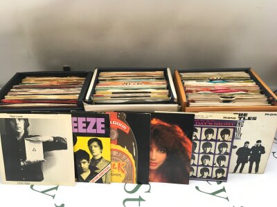 Five record cases of 7" singles and EPs by various artists including The Beatles, David Bowie, Queen, Kate Bush and many more.