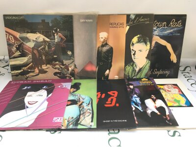 A record case containing rock and pop LPs by various artists including Sparks, Duran Duran, Tubeway Army and others.