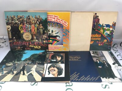 Eight Beatles LPs comprising Apple reissues and compilations including Abbey Road, Rarities, Hey Jude and others.