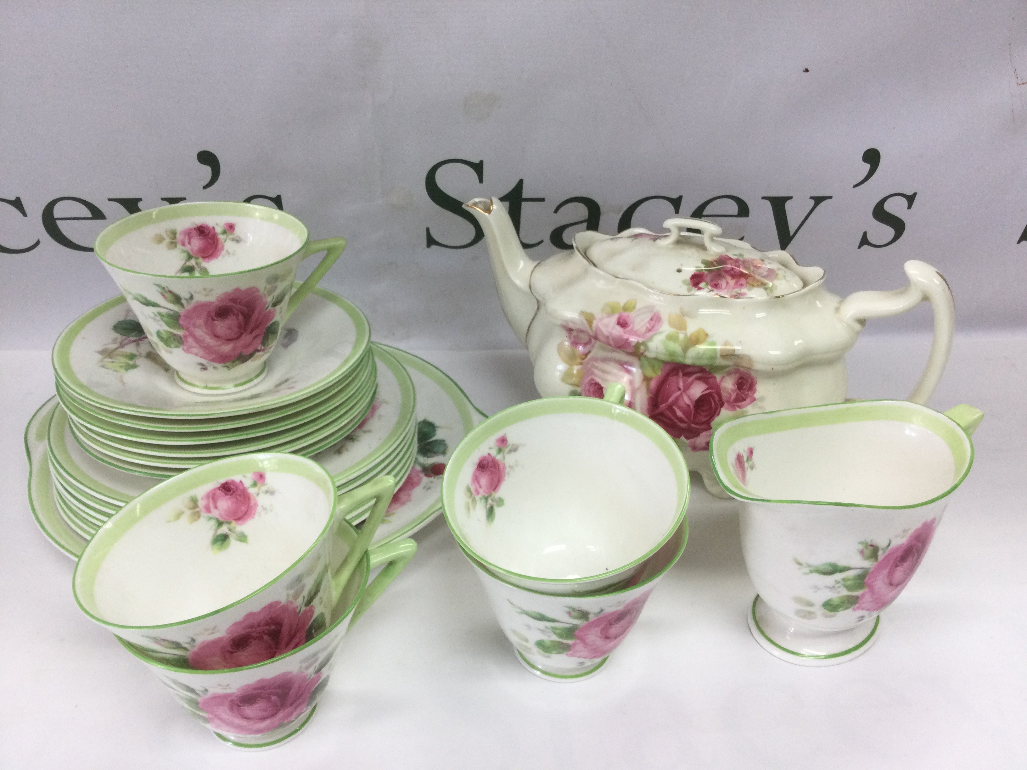 A collection of Royal Doulton teaware in June pattern plus a Doulton teapot. Shipping category D.