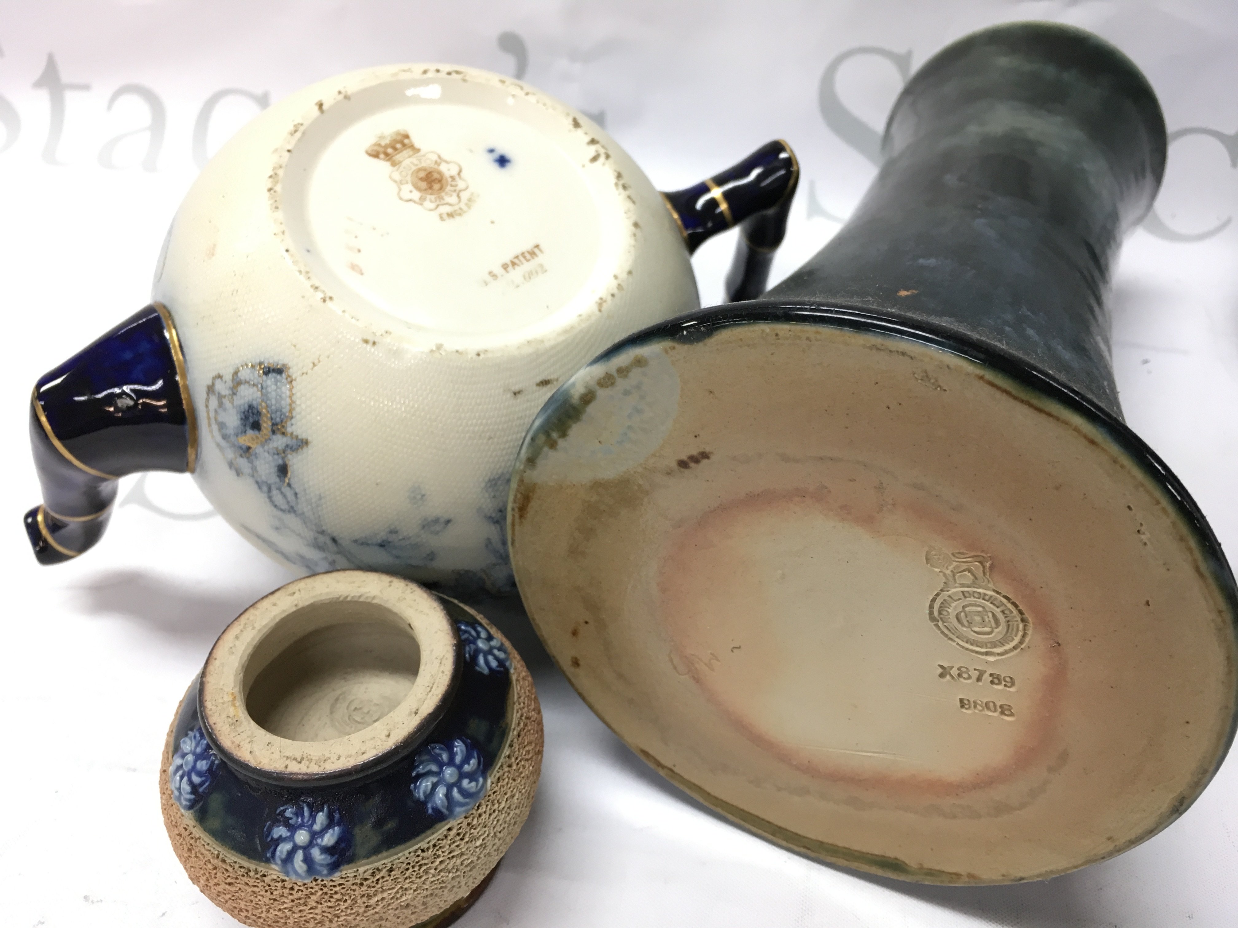 A collection of Royal Doulton stoneware vases and a Doulton Burslem US patient blue and white floral and gilt tea pot . This lot cannot be posted. NO RESERVE