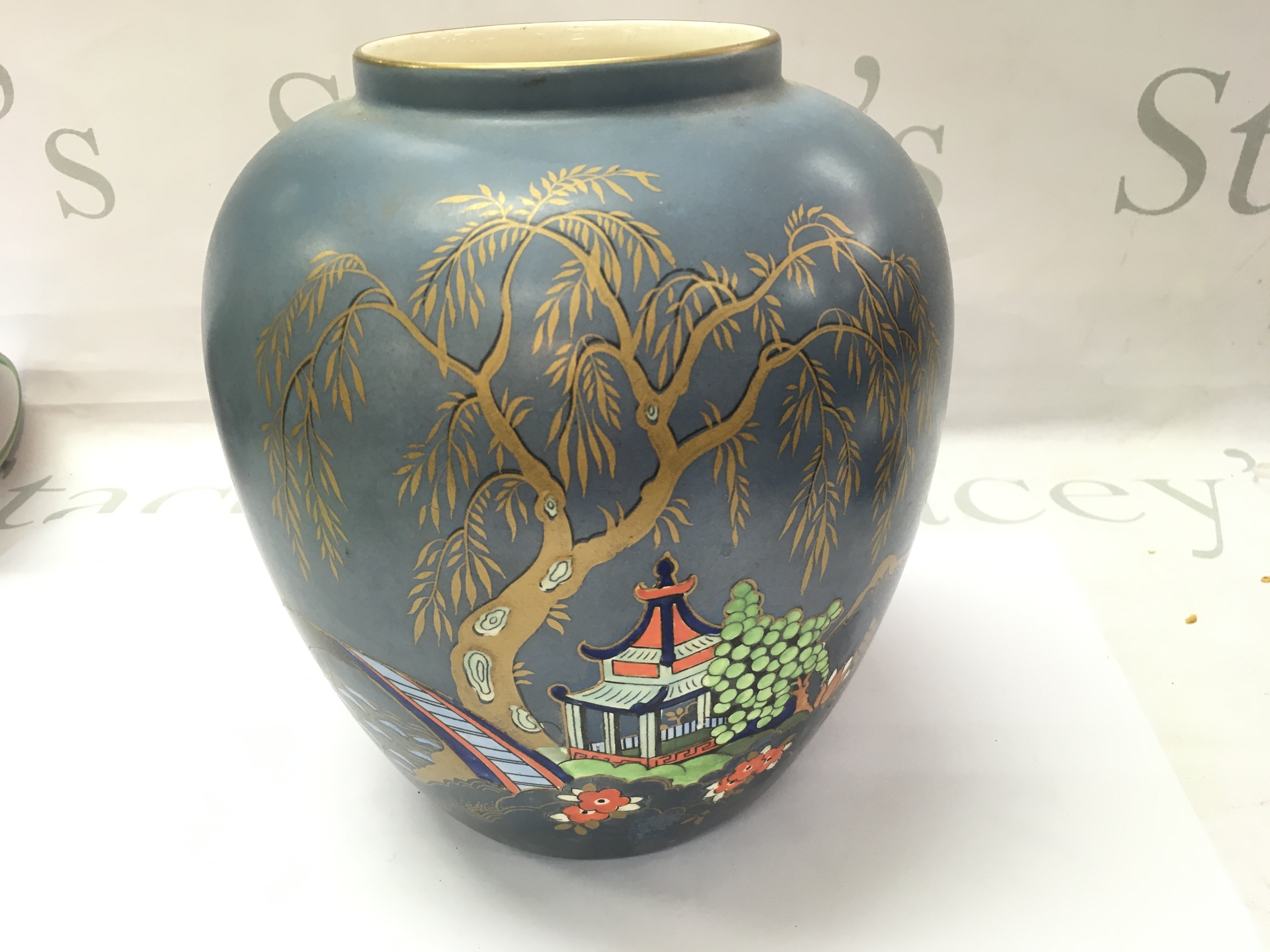 An Art Deco vase with an oriental painted scene. 20cm tall.