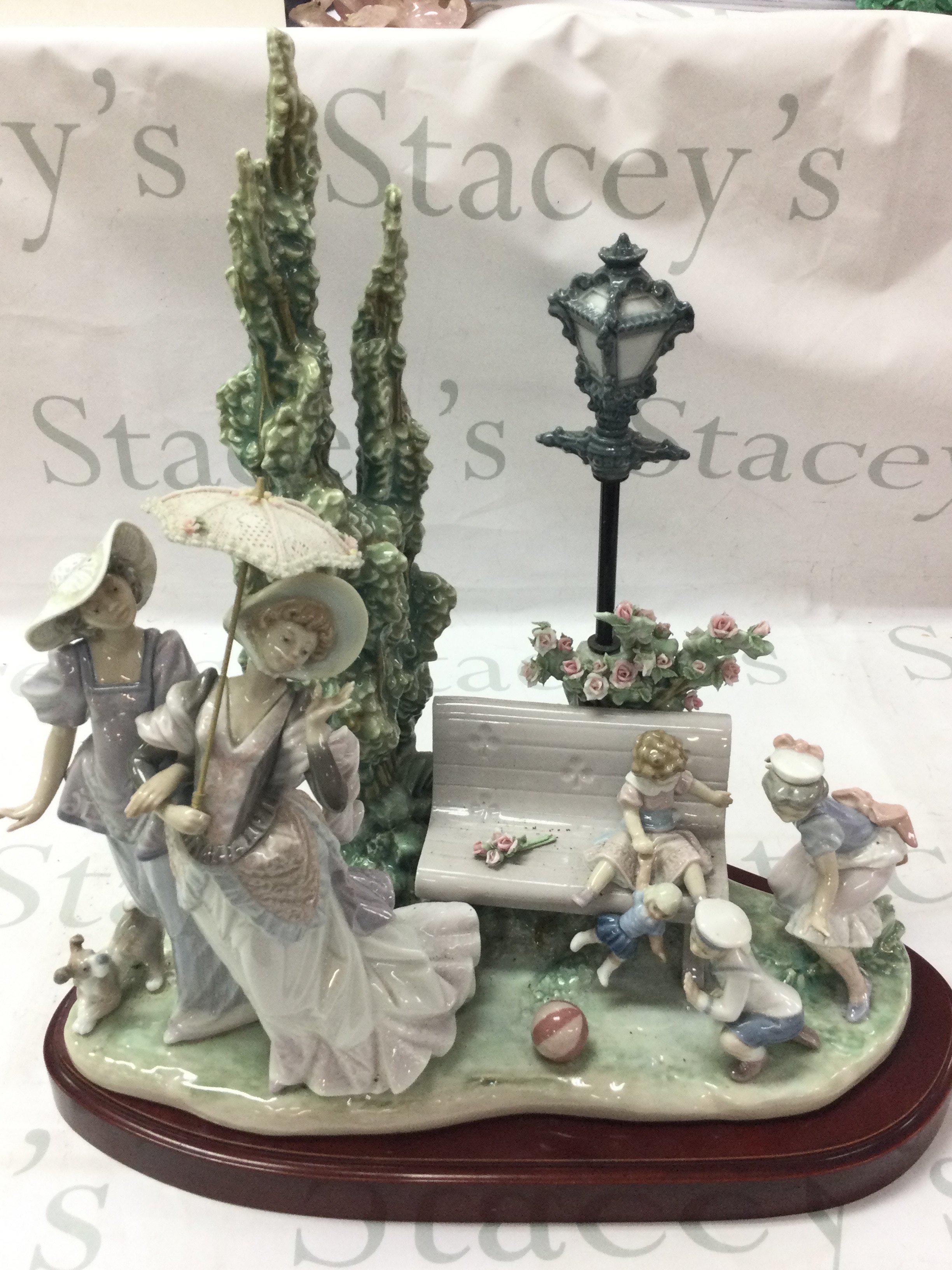 Lladro a Stroll in the Park figure group with stand, no obvious damage or restoration however the dog figure needs re gluing to the base. This lot cannot be posted