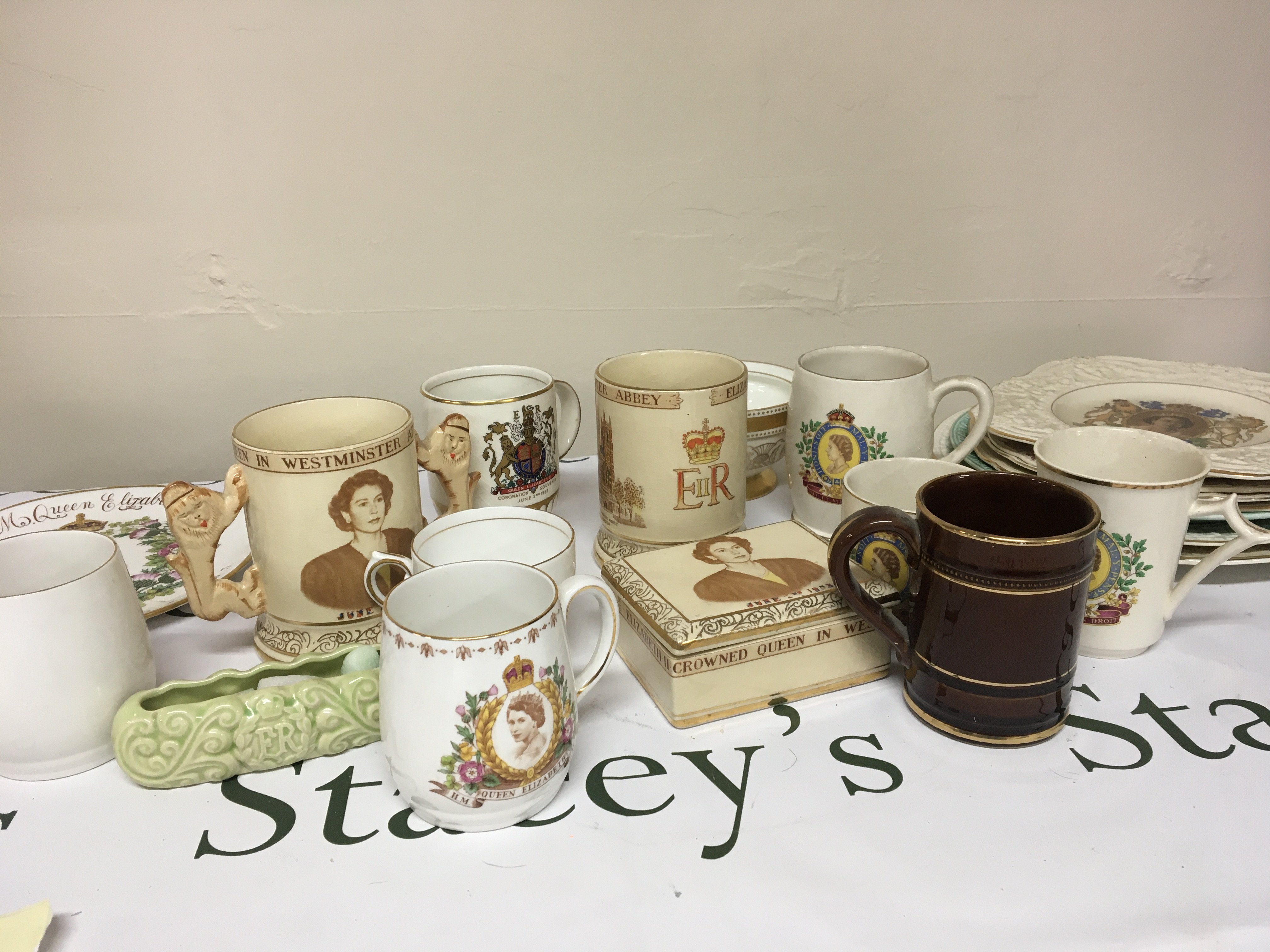 A collection of Royal Commemorative Elizabeth II coronation ceramics and porcelain cups mugs plates and two tin trays. NO RESERVE.