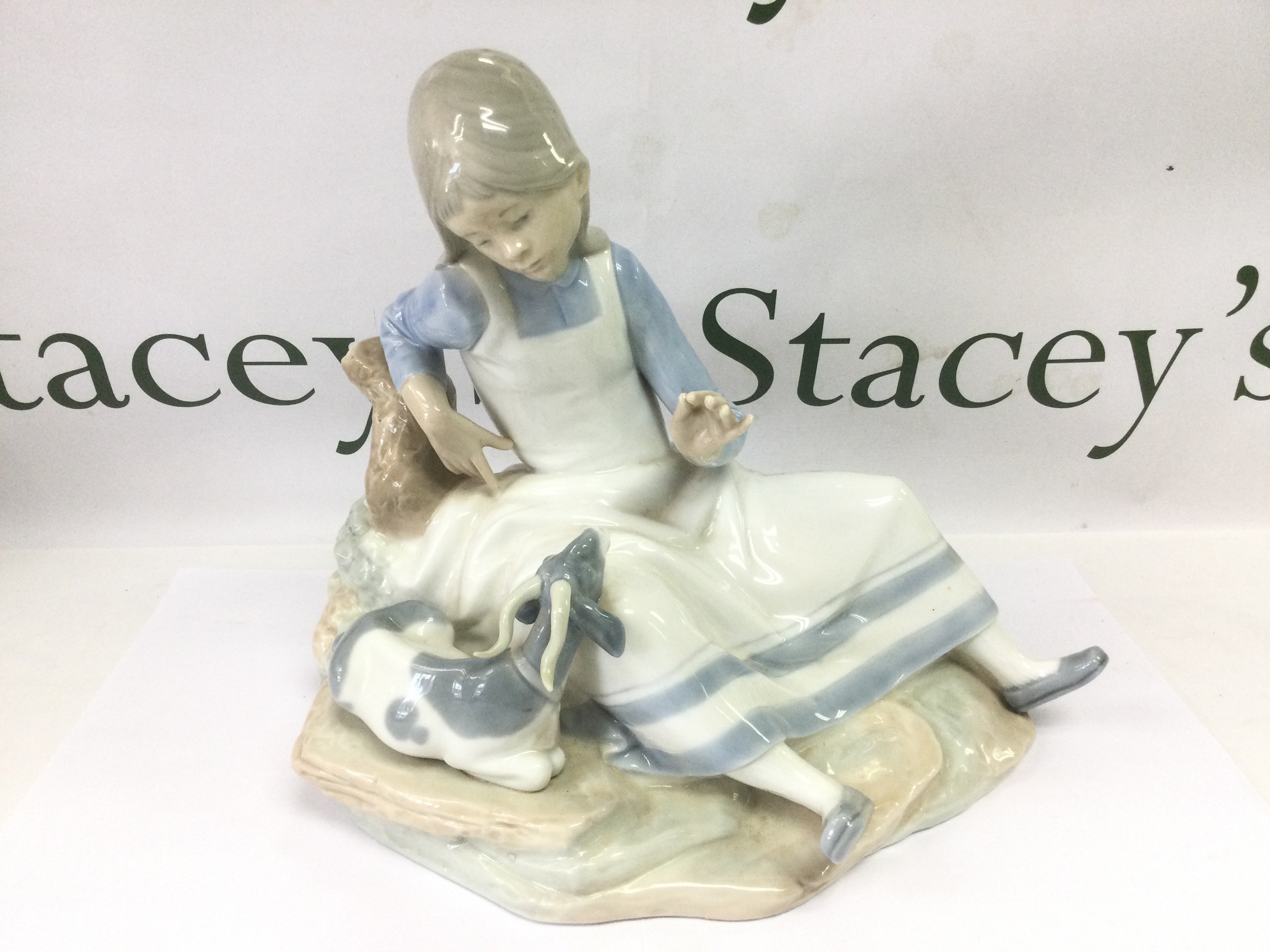 A Lladro figural group of a girl with a goat at her side, approx height 24cm. Shipping category D.