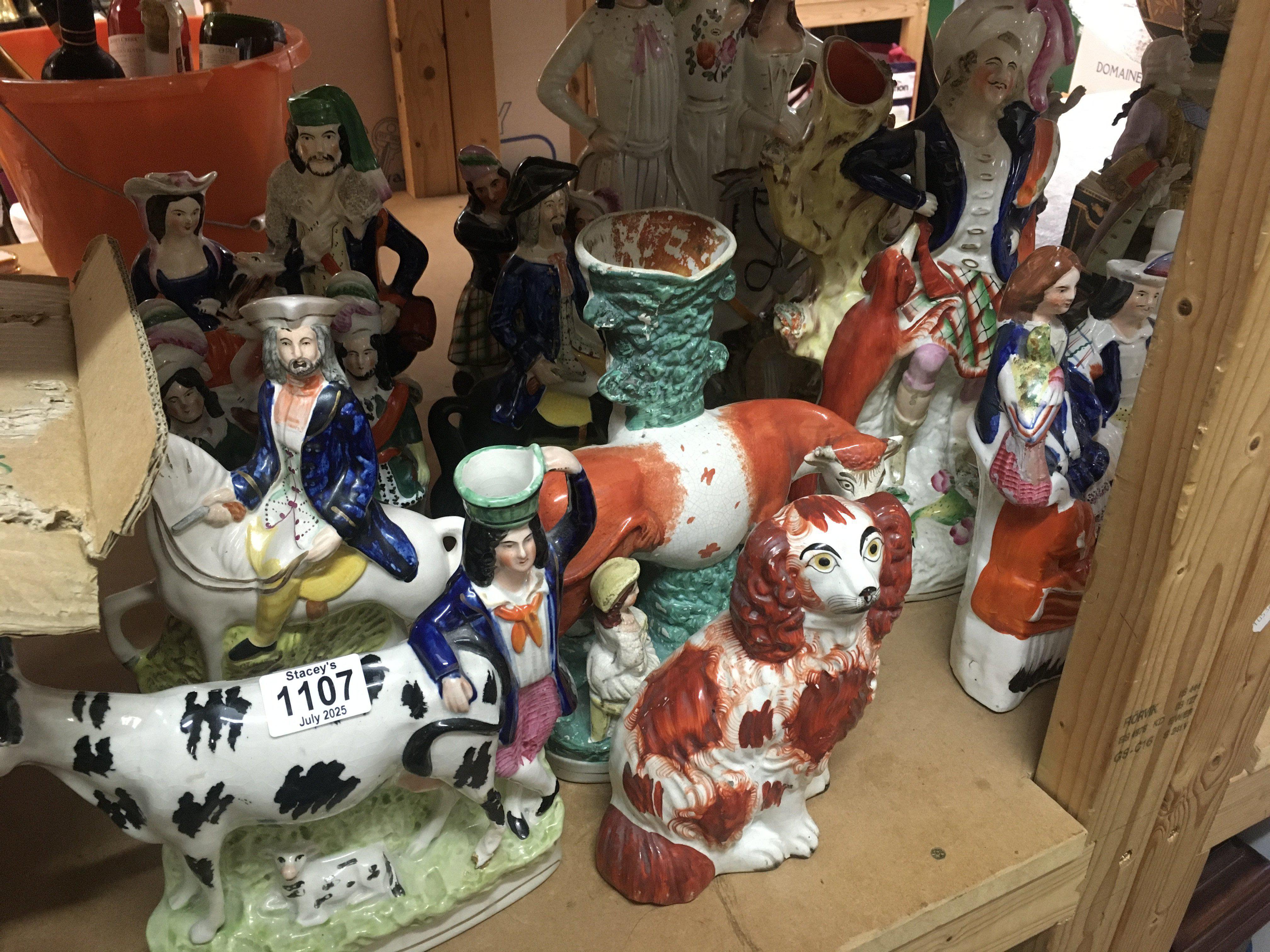 A collection of twelve Staffordshire figures including spill vases .