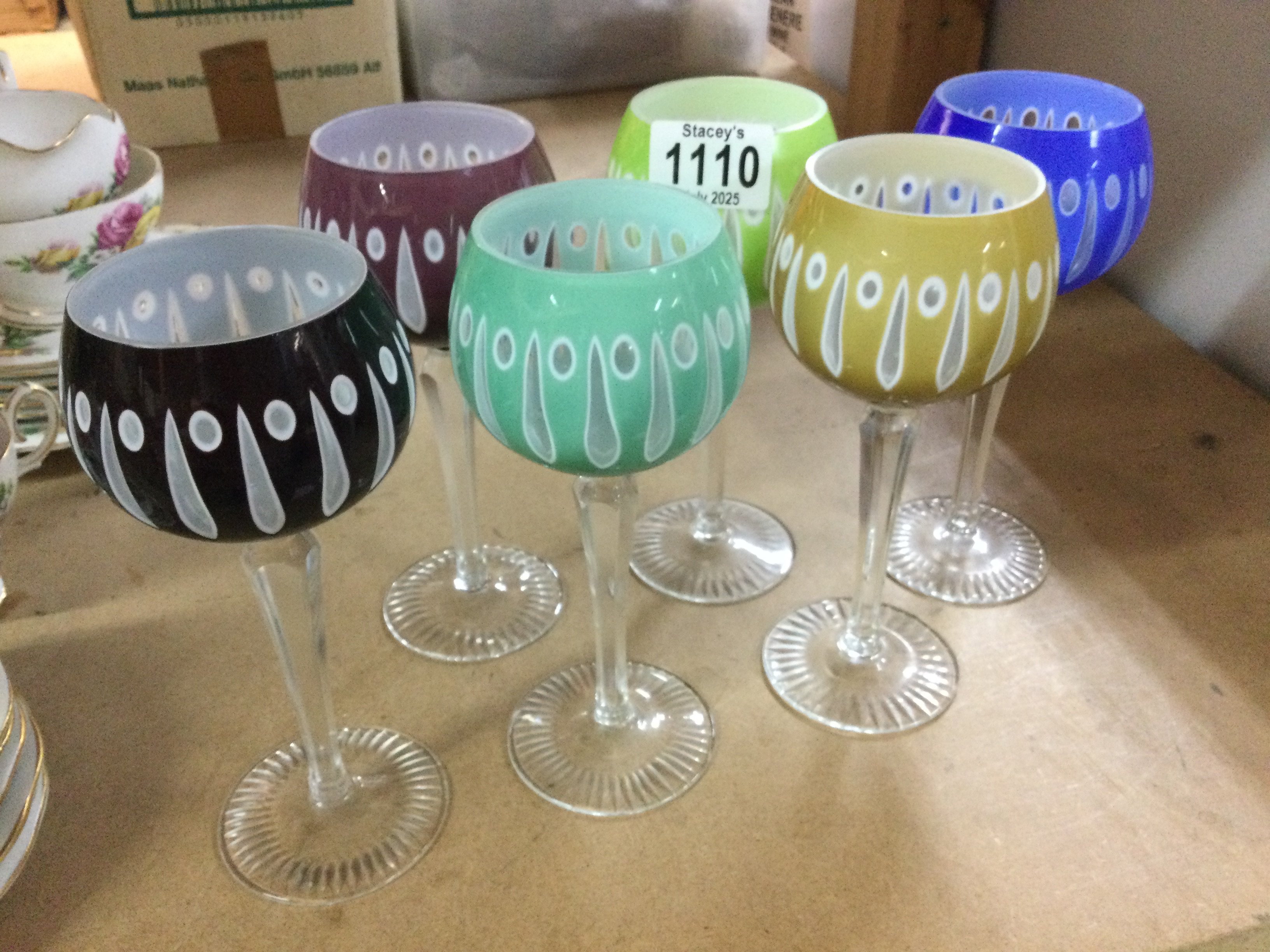 A collection of six coloured wine glasses and three others .