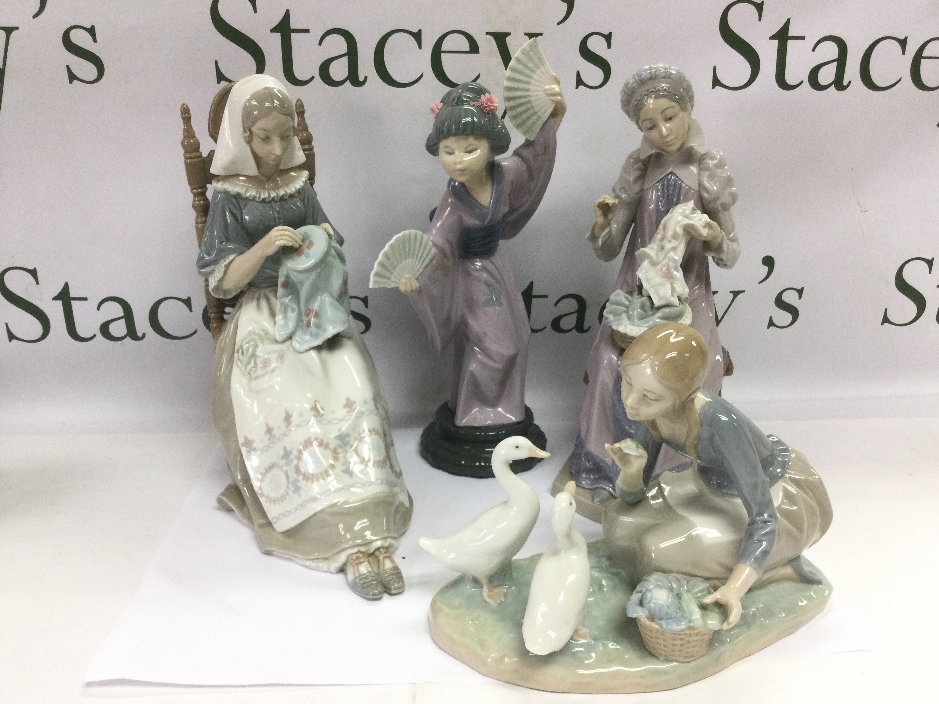Four Lladro figures of ladies, tallest approx 30cm. Shipping category D.