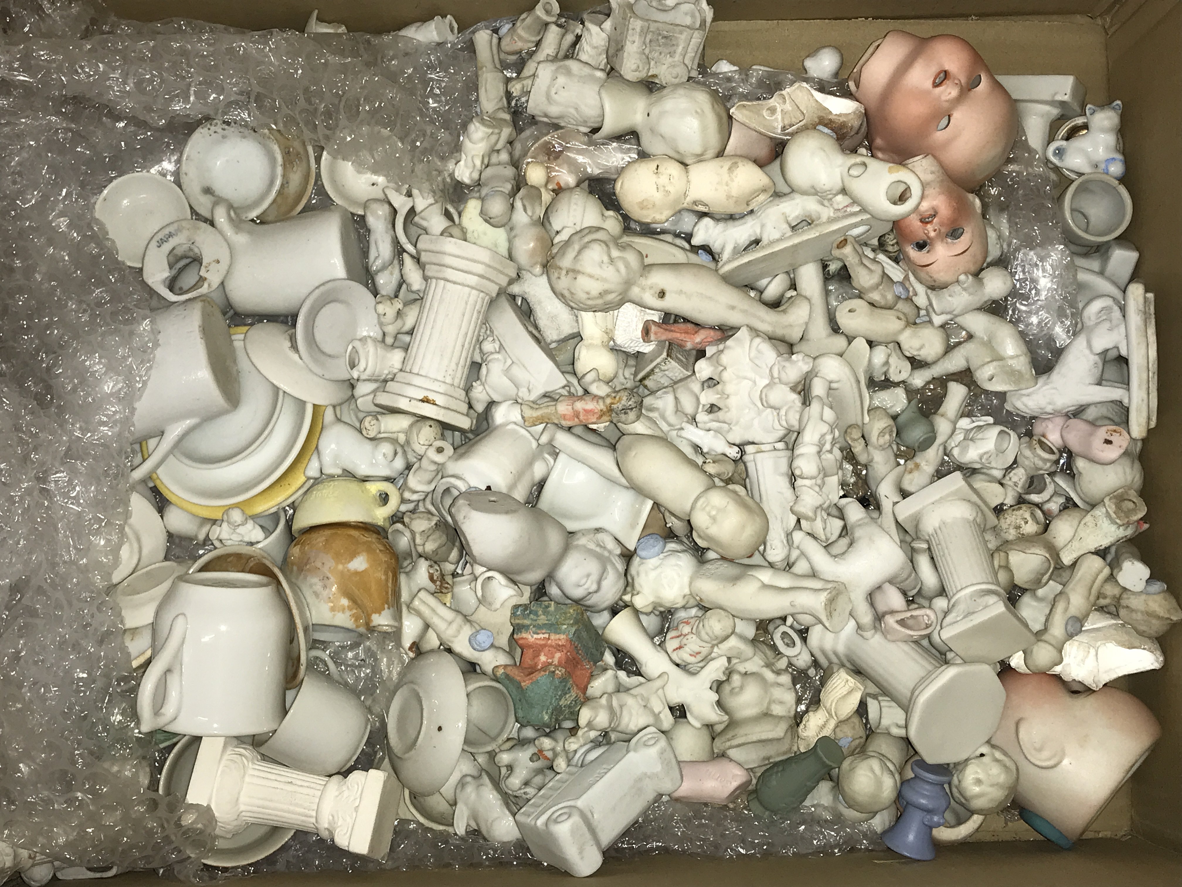 A case containing miniature dolls , Victorian and later. This lot cannot be posted